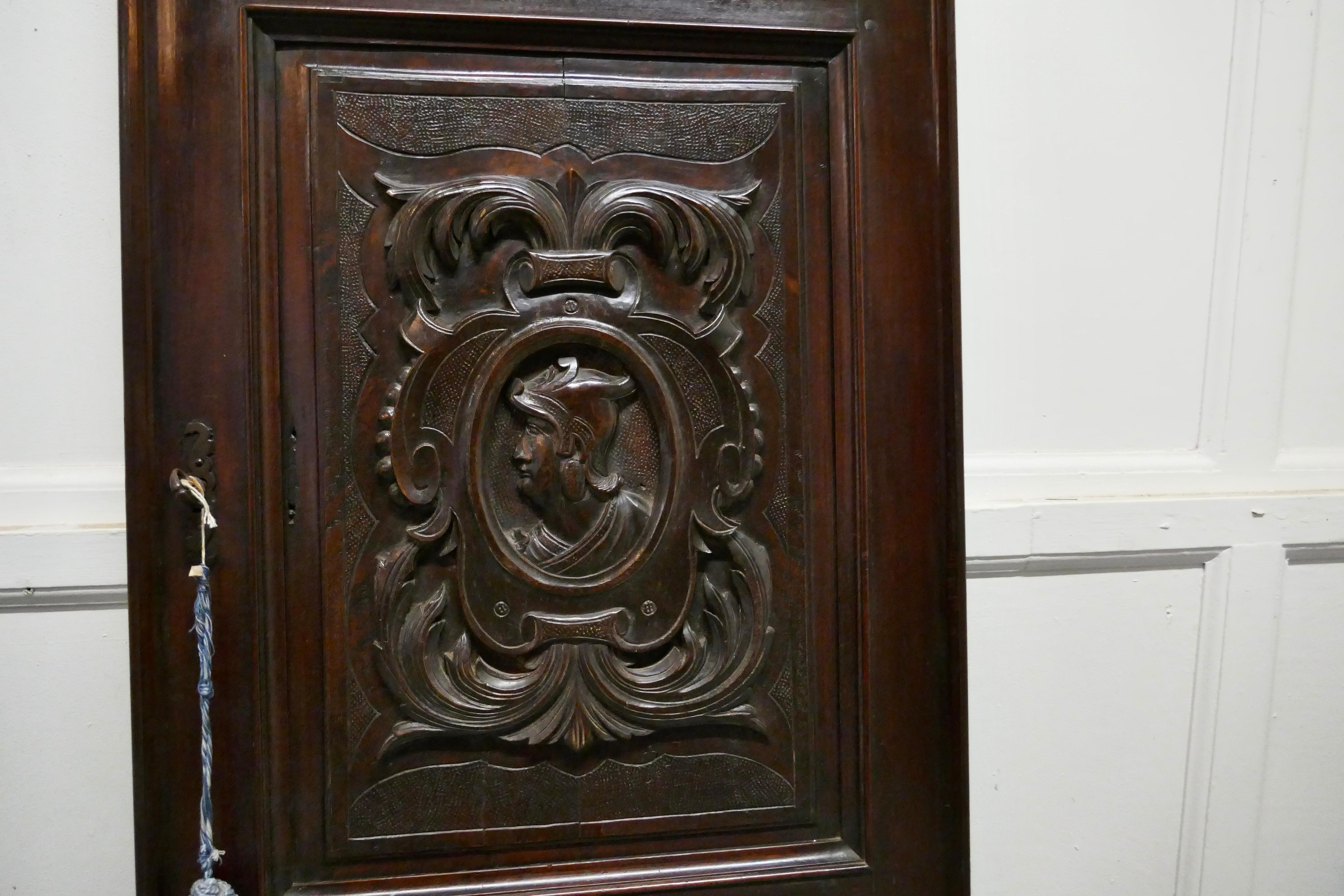 19th century French carved oak panel door.

The door is from a 19th century oak cupboard, it has 3 carved panels, the top and bottom panels are in Celtic patterns typically from the Breton region of France the centre one is of a warrior

The