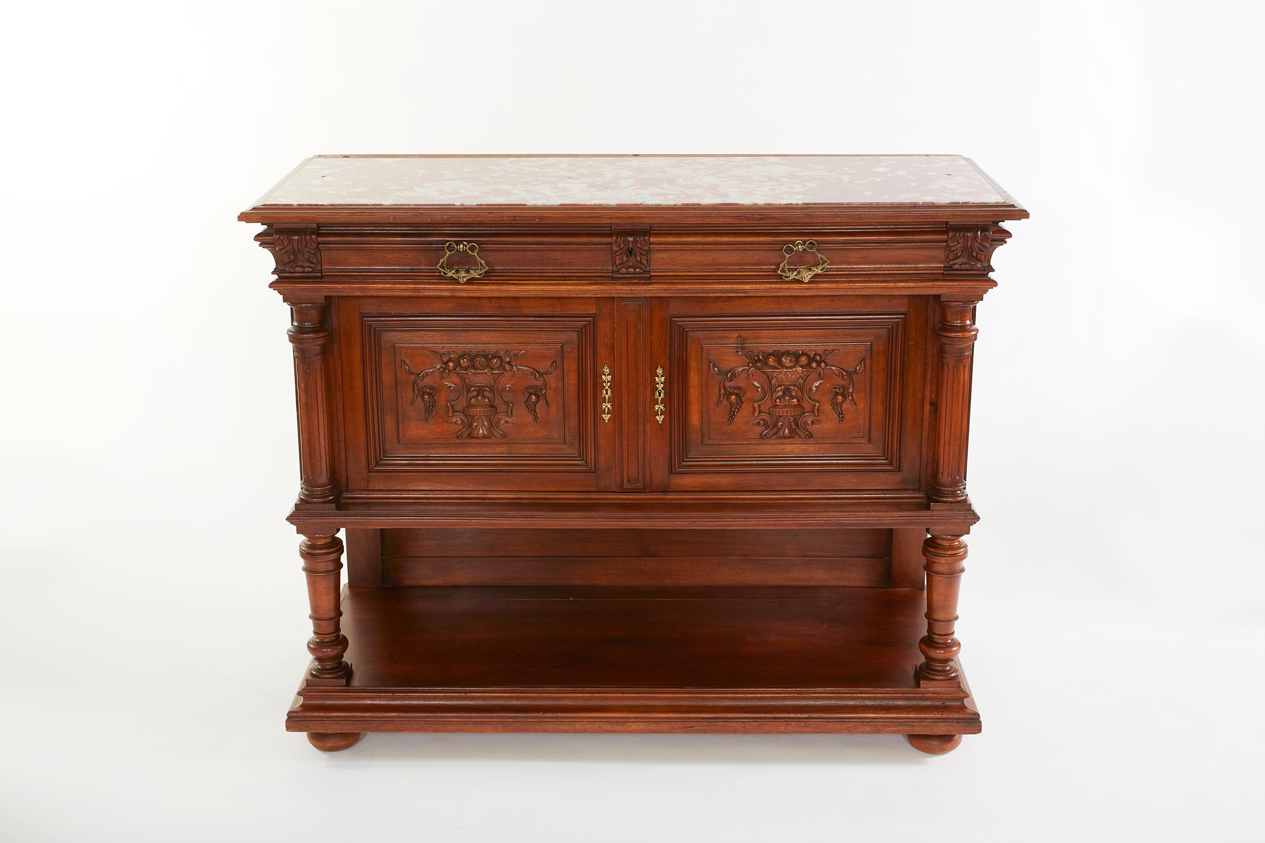 Mid 19th century French carved oak renaissance style server / sideboard with front doors / front drawers and exterior hand carved design details. The sideboard / server is in great condition. Minor wear consistent with age / use. The server measure
