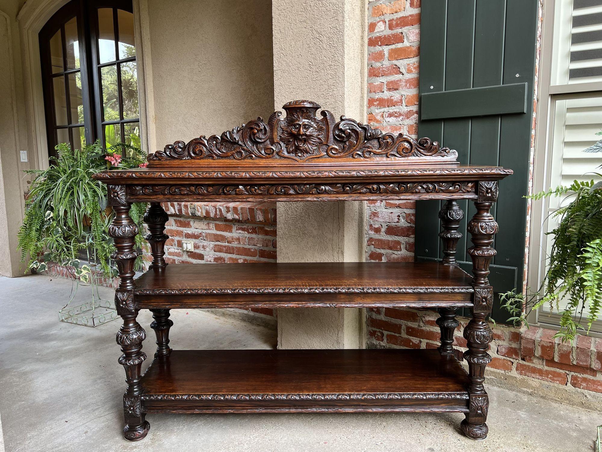 19th century French Carved Oak sideboard server table Renaissance Bar Shelf.
 
Direct from France, a gorgeous, highly carved 19th century sideboard/server.
Large back crown, fully carved, center mask surrounded with carved scrolls and foliate.