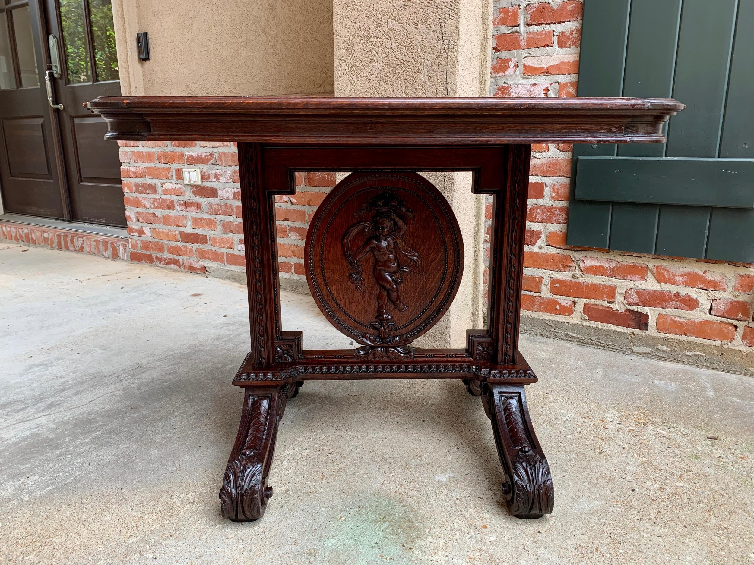 19th century French carved oak sofa side table Renaissance cherub angel

~Direct from France~
~Unique hand carvings on this versatile antique French side table~
~Lower table highlight is the center oval medallion with a full figural carved standing