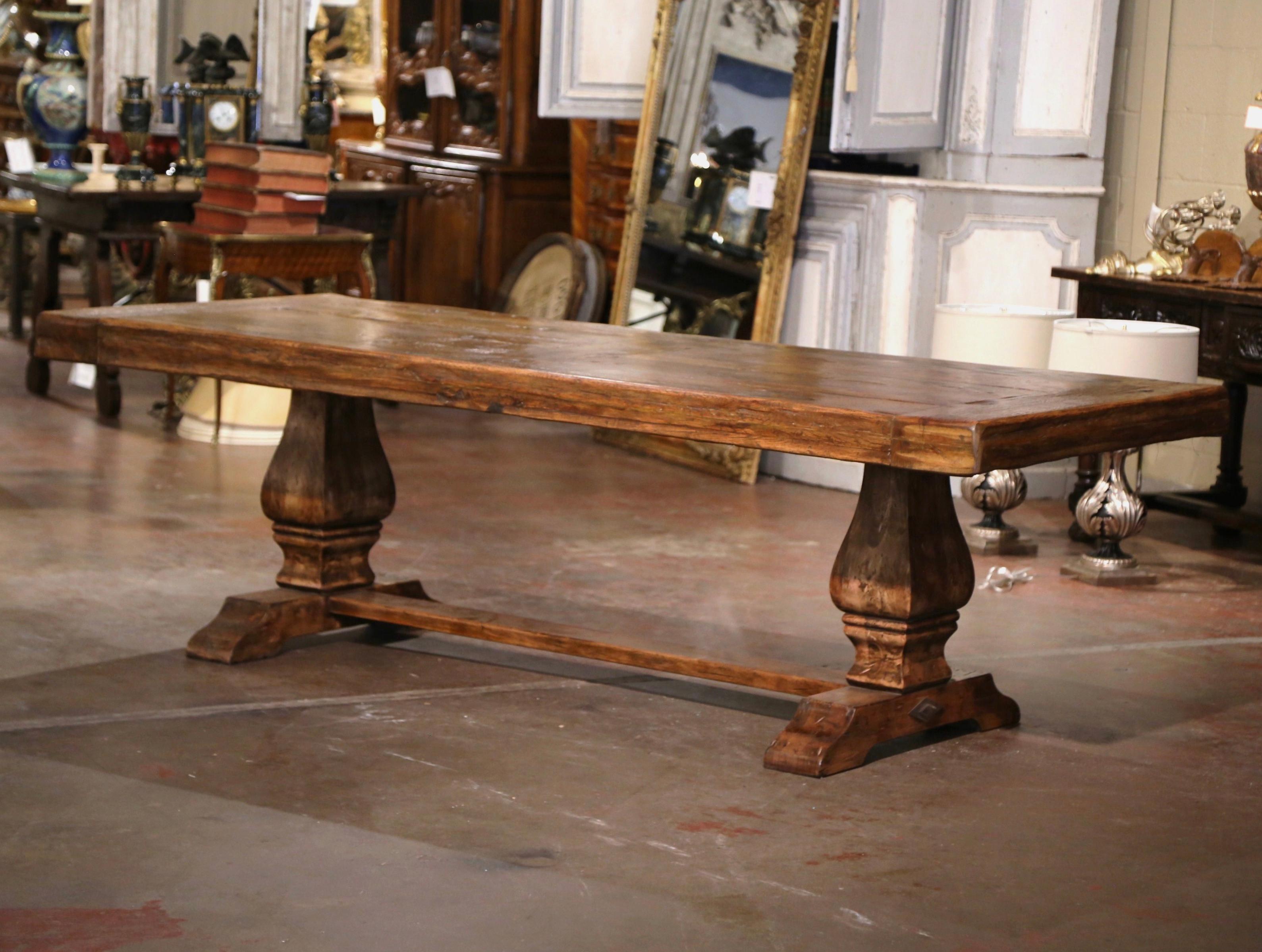 This large 8 feet long antique dining table was crafted in southwest France circa 1860. Built with antique and reclaimed old timbers of oak, the extremely authentic heavy table stands on an elegant trestle base from latter addition, supported with