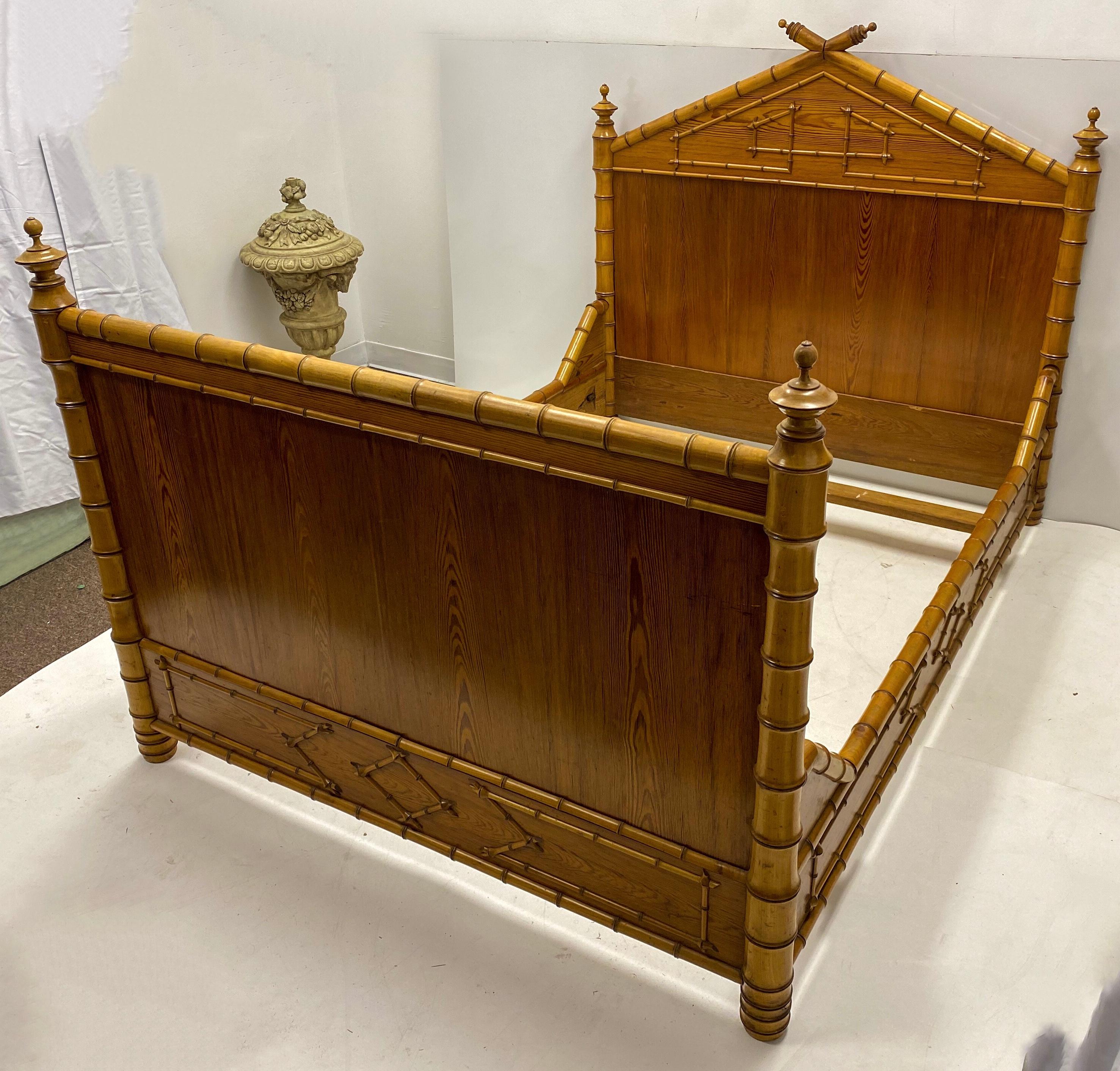 This is a 19th century French carved pine faux bamboo bed frame. It is European in size, which is closer to a full in the United States. The frame has a hard pine foundation with elaborate faux bamboo details.