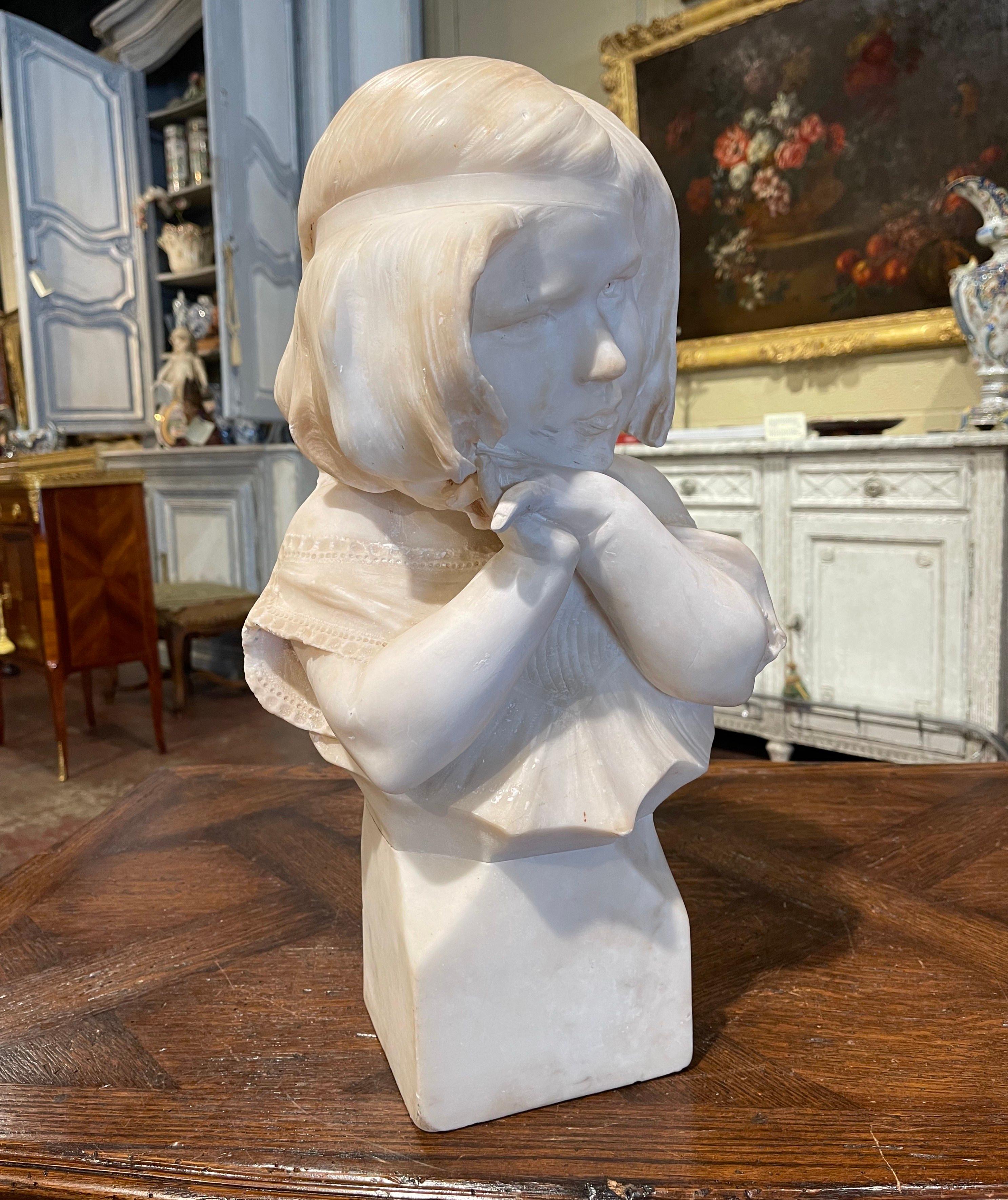 Crafted in France circa 1890, this antique marble bust is a true representation of French elegance. The figural sculpture stands on an attached white and grey square base, and features a beautiful, young girl in a lace dress with delicately posed