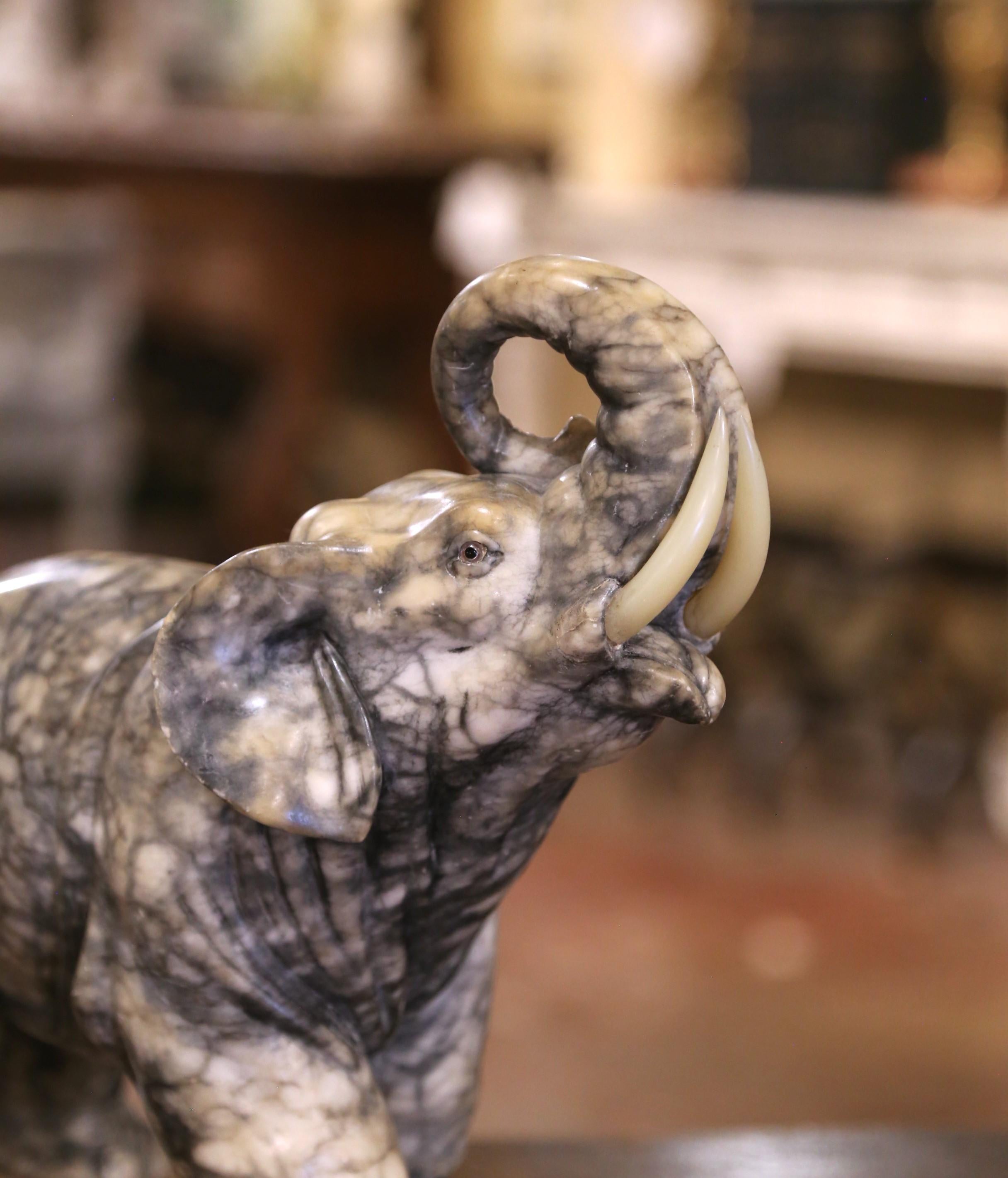 Marmo 19th Century French Carved Variegated Marble Elephant with Raised Trunk in vendita