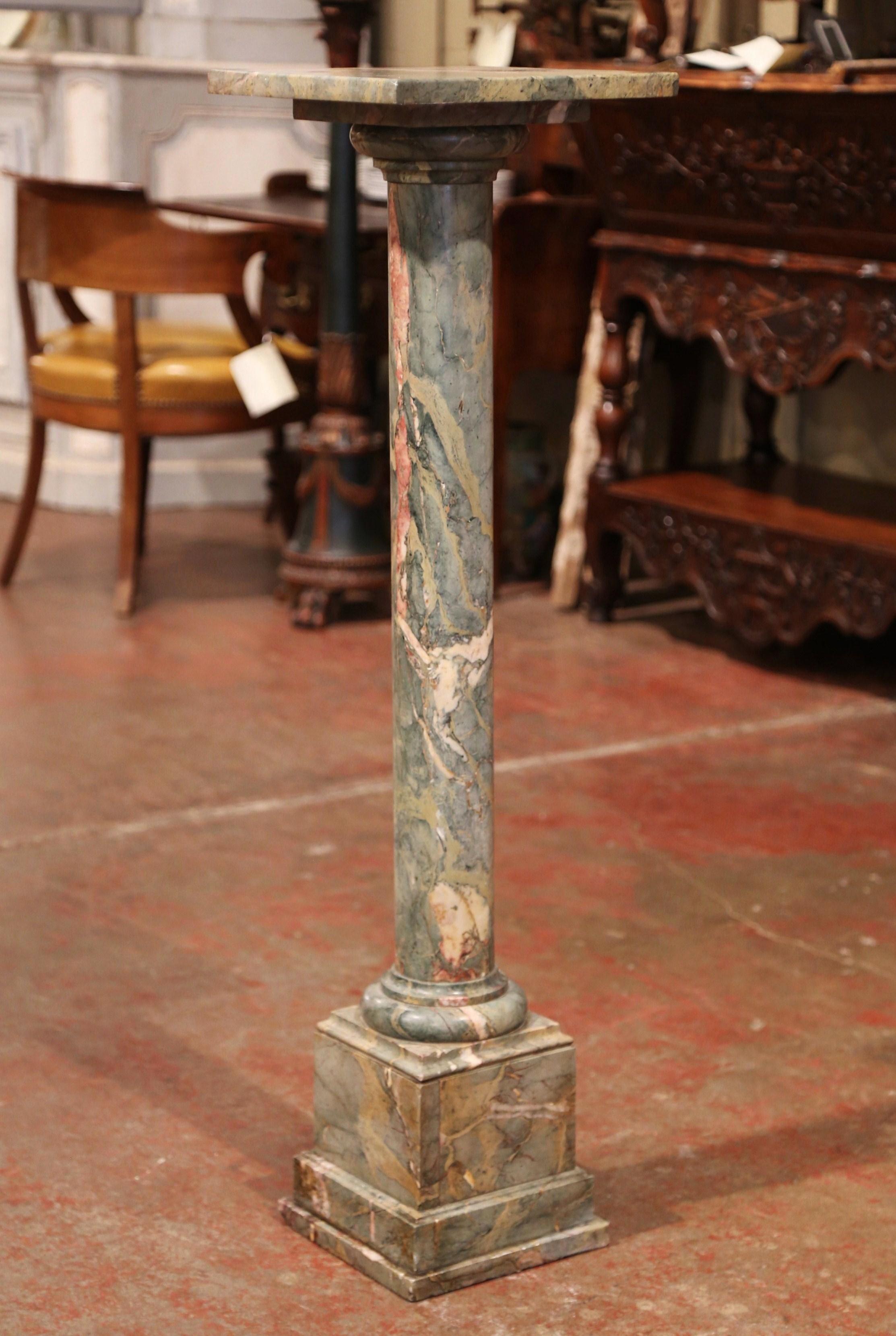 This elegant, antique multi-color marble pedestal table was crafted in France, circa 1880. The Napoleon III pedestal sits on a sturdy square plinth base; it features a round stem, and the top has a removable swivel square surface. The tall pedestal