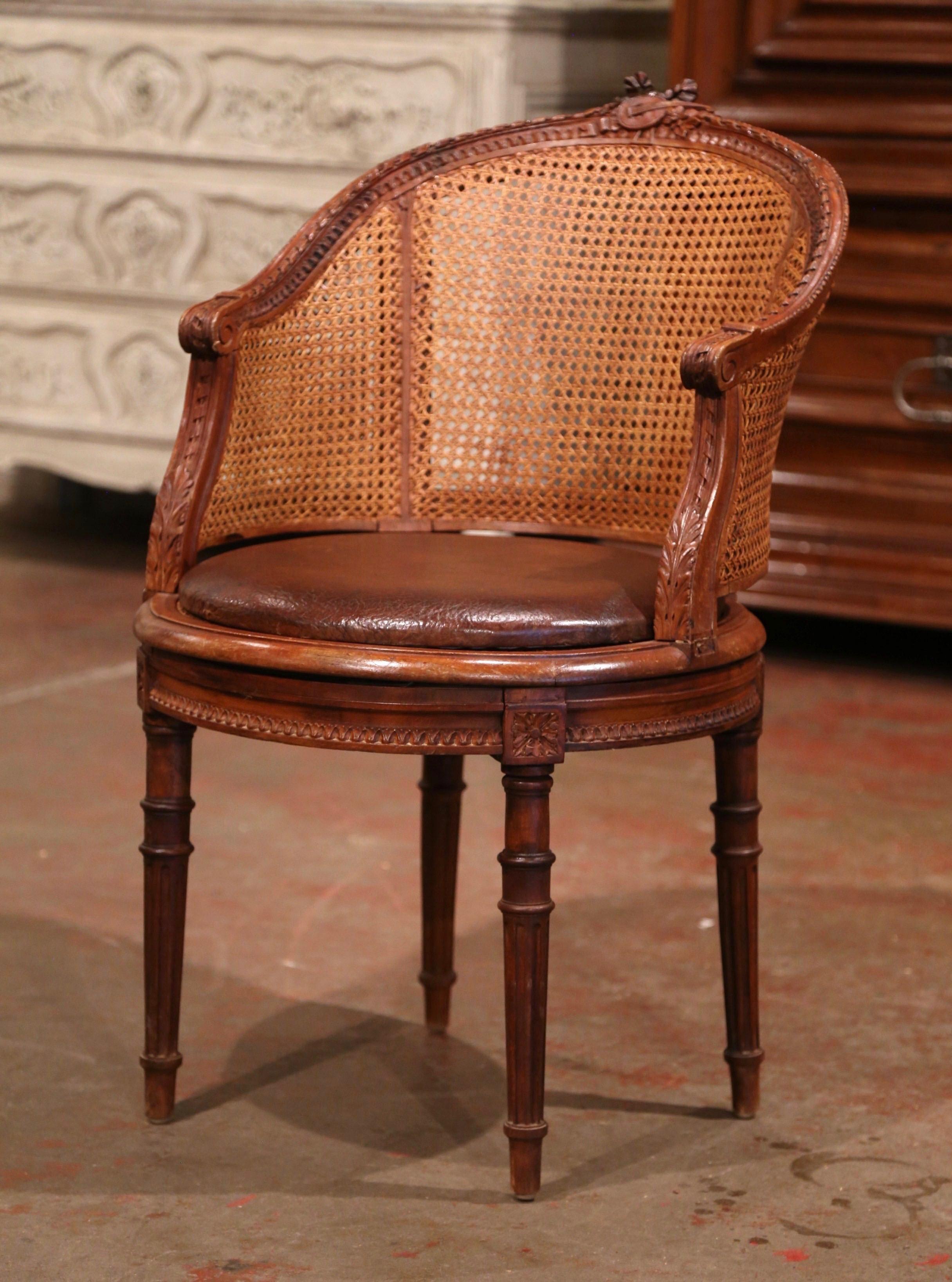 Decorate a study or office with this elegant antique fruitwood desk armchair. Crafted in Provence, France, circa 1870, the desk chair stands on four tapered and fluted legs decorated with floral rosettes at the shoulders, over a carved apron with