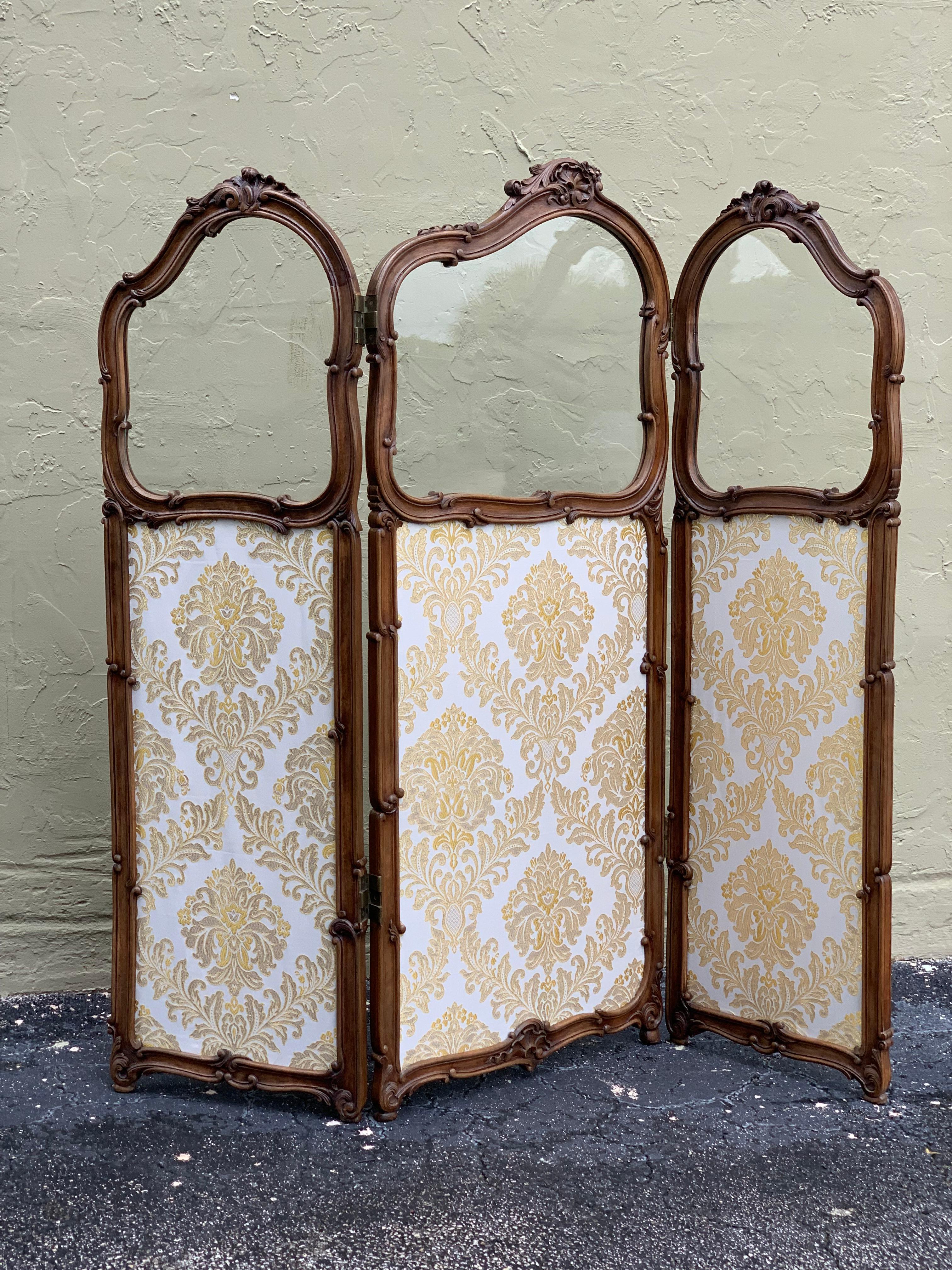 This lovely and delicately designed French carved walnut and gilt three-fold screen is circa 1890 and features the original bevelled glass panels on the top.
Recently upholstered.
  