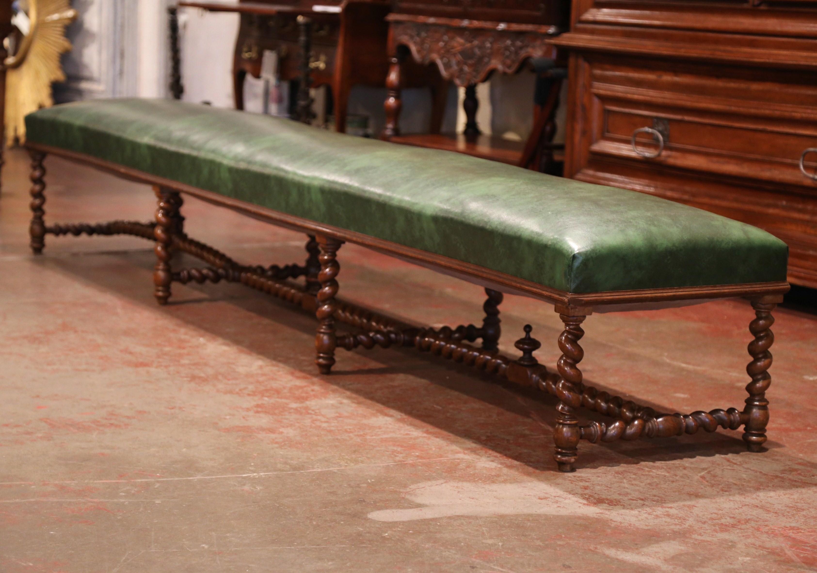 Add extra seating to an entry or a game room with this long antique fruitwood bench. Crafted in Southern France circa 1870, the bench was found in a large chateau in the Perigord region. The traditional Louis XIII style bench features eight barley