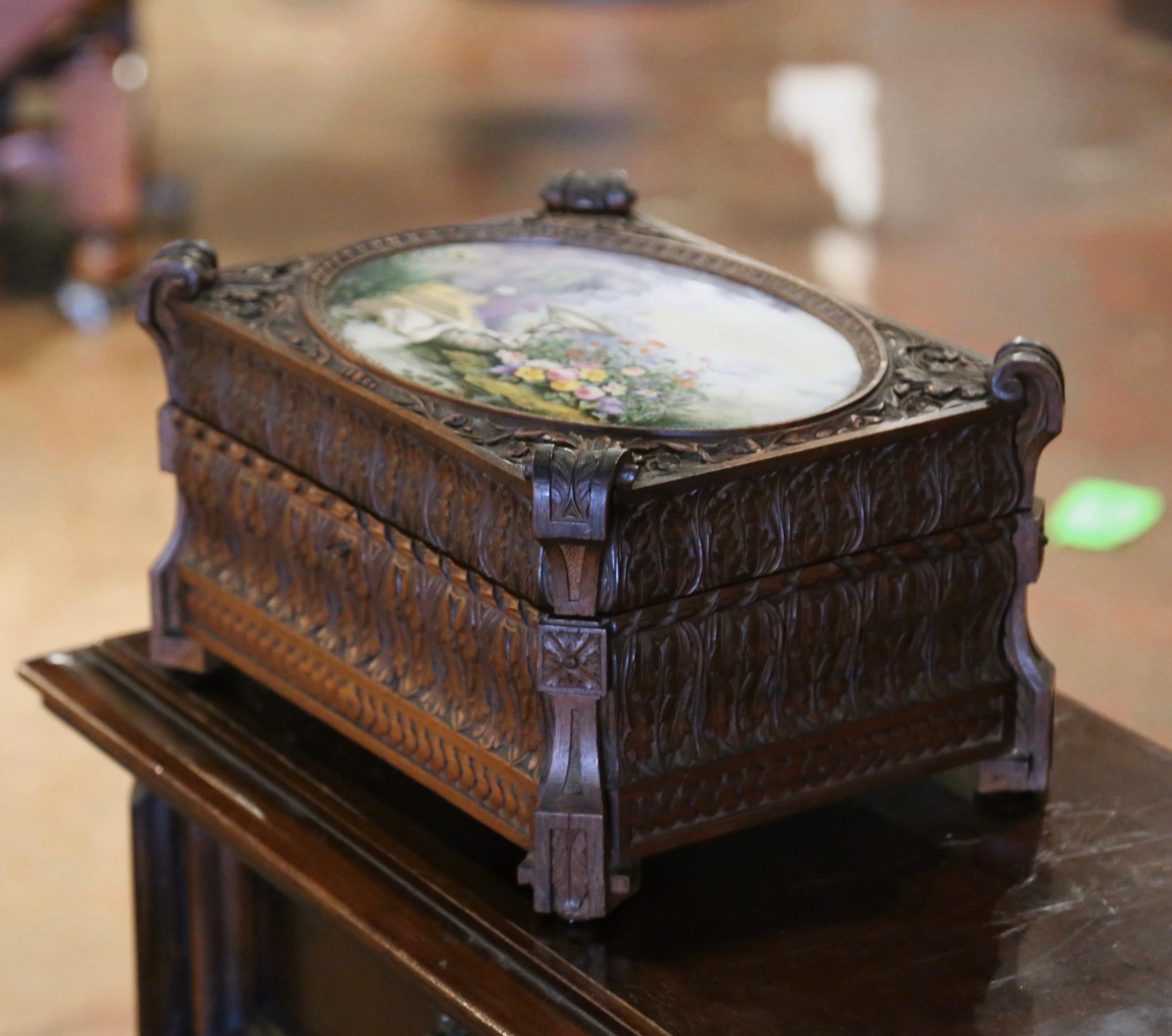 Gardez vos objets de valeur en sécurité et organisés dans cette élégante boîte à bijoux ancienne. Fabriqué à Paris en France par la Maison Fichet vers 1860, ce coffret coloré repose sur de petits pieds en forme d'équerre. La boîte est décorée de