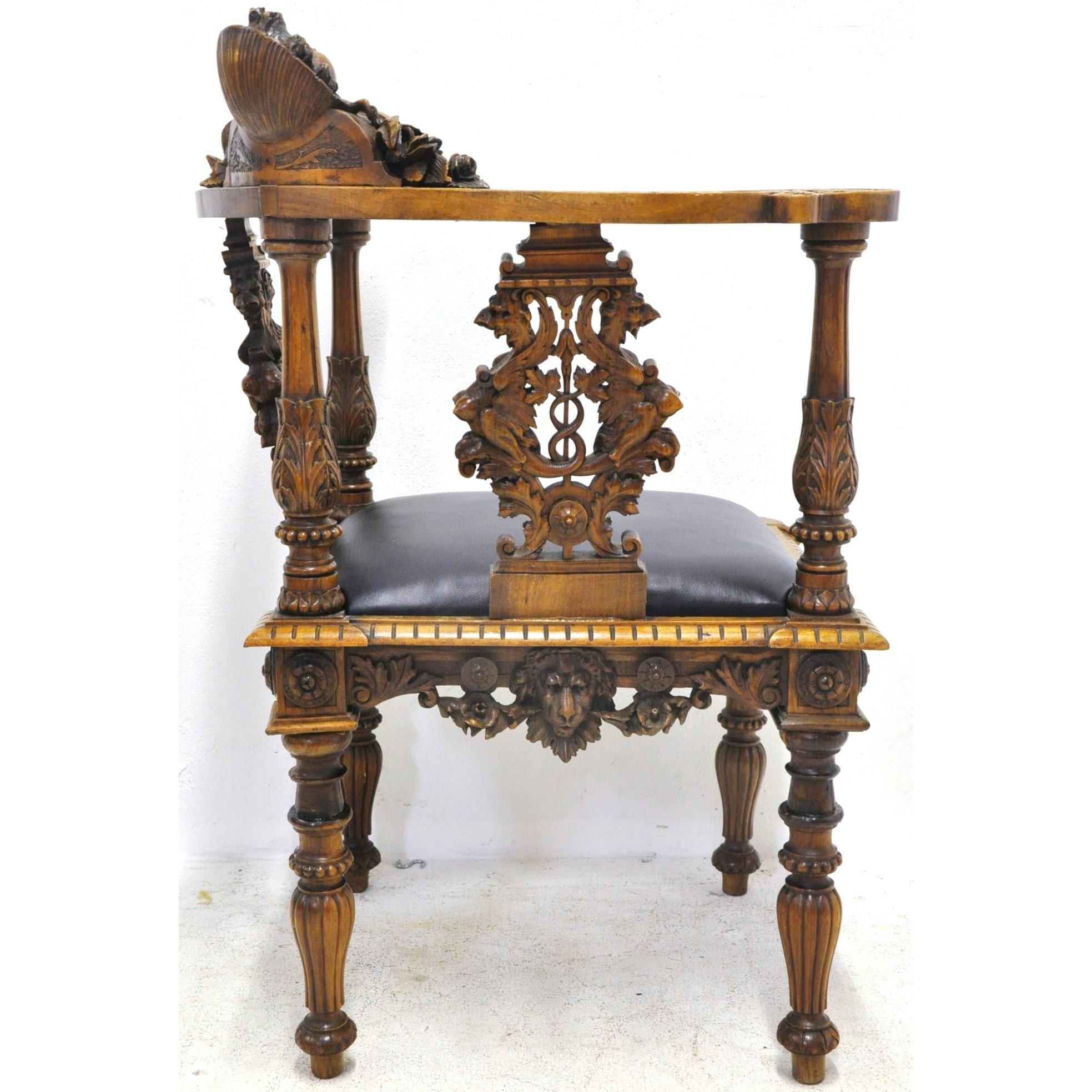 This Napoleon III fruit wood armchair was crafted in France, circa 1860. The antique piece has a unique shape, with intricate decorative and figural carvings throughout the frame including the face of an angel and of a lion. The seat is upholstered