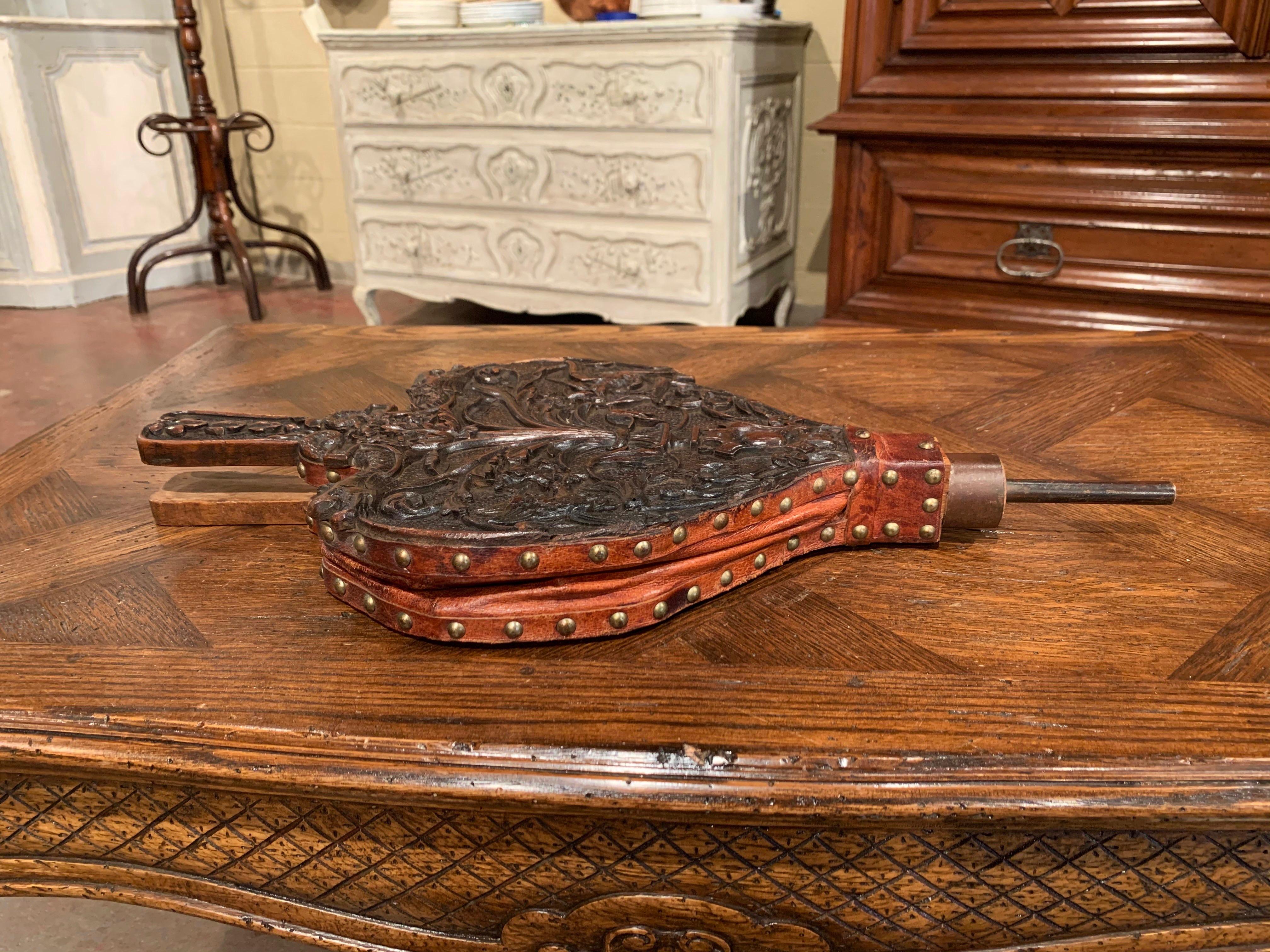 Decorate a fireplace and active the flames with this elegant and useful antique bellows, crafted in France circa 1860, the fireplace essential features a heavy carved top surface with two handles at one end, an iron blower at the other extremity,
