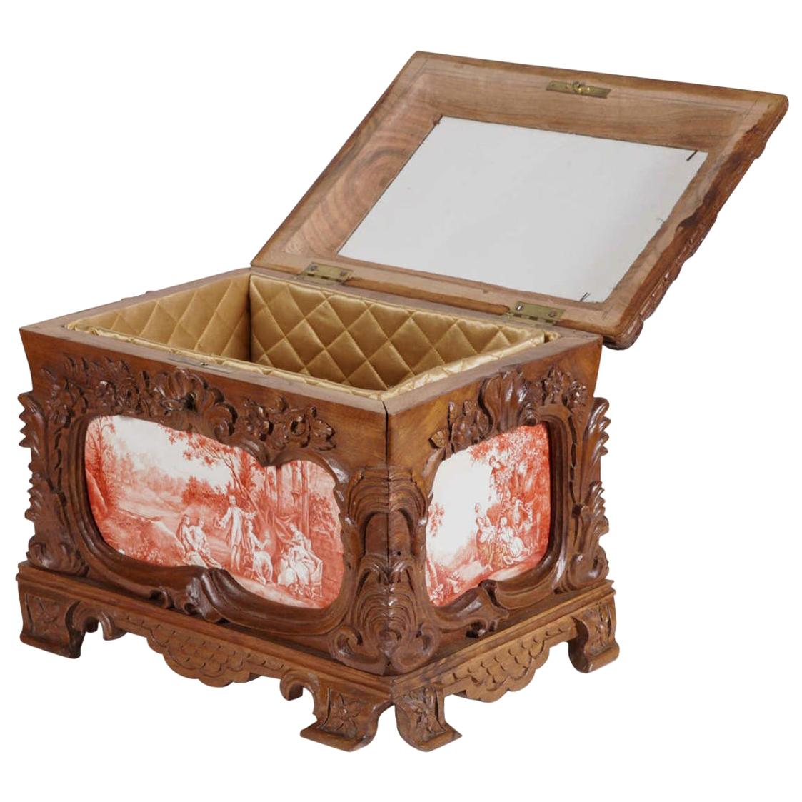 Store jewelry on your vanity or closet with this beautifully carved antique fruitwood jewelry box. Crafted in France, circa 1860, the elegant cabinet sits on small, ornate feet over a scalloped apron, and features four enamel tiles decorated with