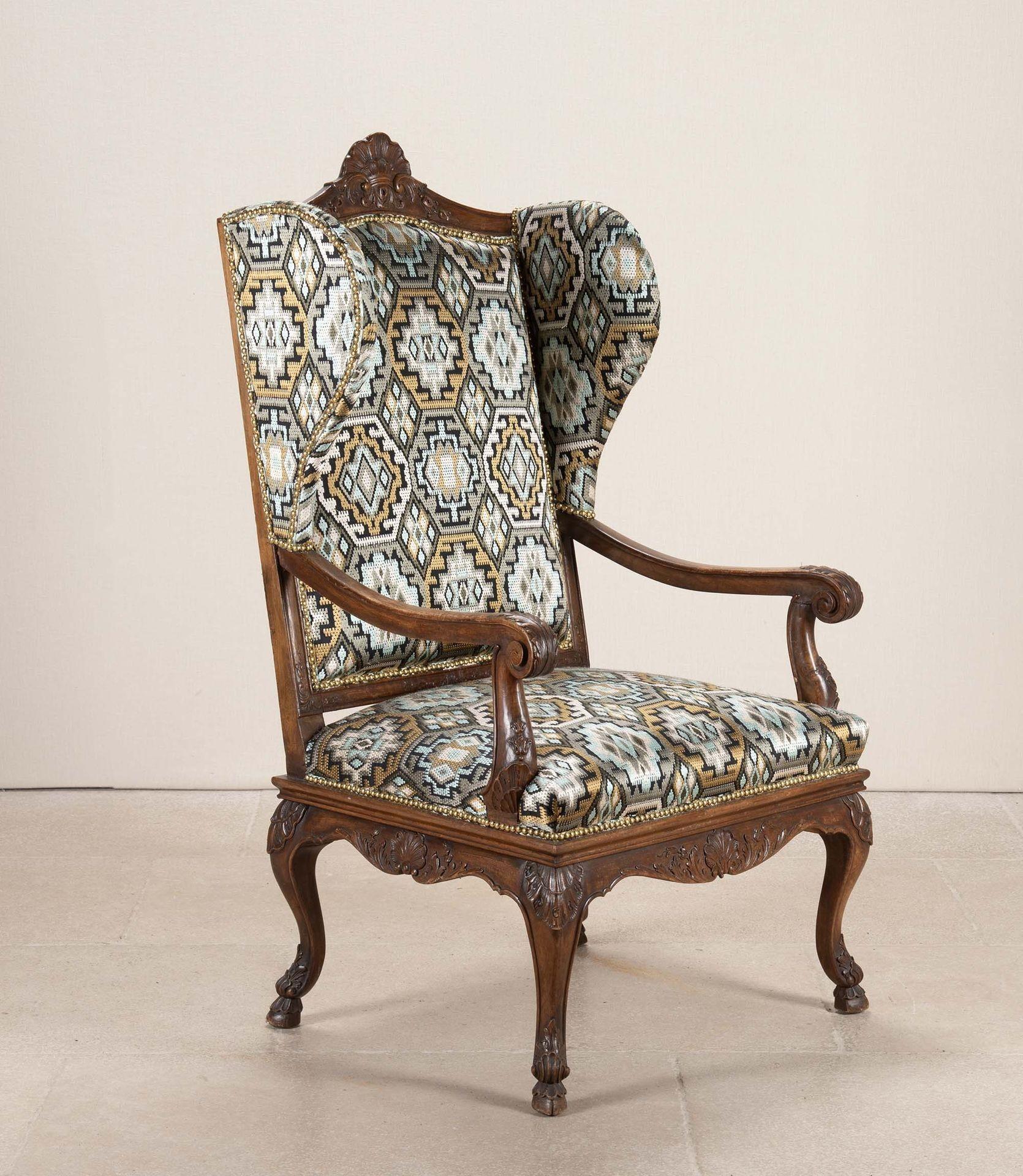 19th Century French carved open armchair. 
Carved crest rail, upholstered wings leading down to acanthus carved scrolled arms. With shaped aprons and central carved shells raised on shapely cabriole legs and hoofed feet.