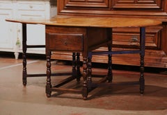 19th Century French Carved Walnut Oval Eight-Leg Drop-Leaf Table with Drawers