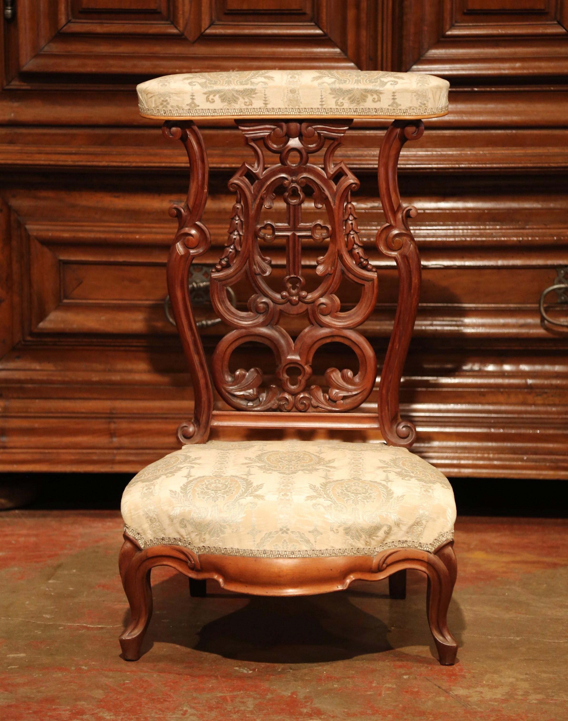 Place this elegant antique prayer chair in your bedroom for daily devotions. Crafted in France, circa 1880, the traditional, fruitwood kneeler has scroll feet, a wide, cushioned seat, and features a large, hand-carved cross further embellished with