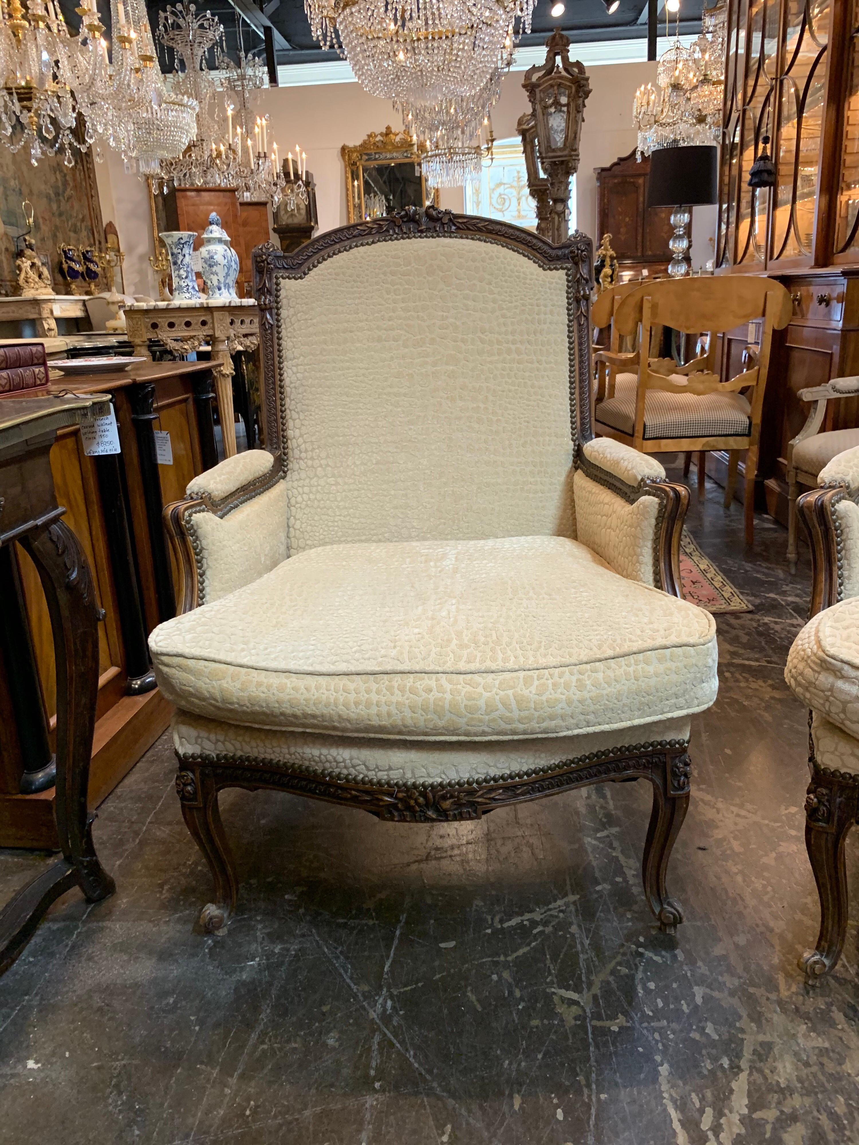 Very fine pair of large scale 19th century French carved walnut armchairs. Incredible intricate beautiful carvings. And upholstered in a lovely crème colored fabric. So elegant!
