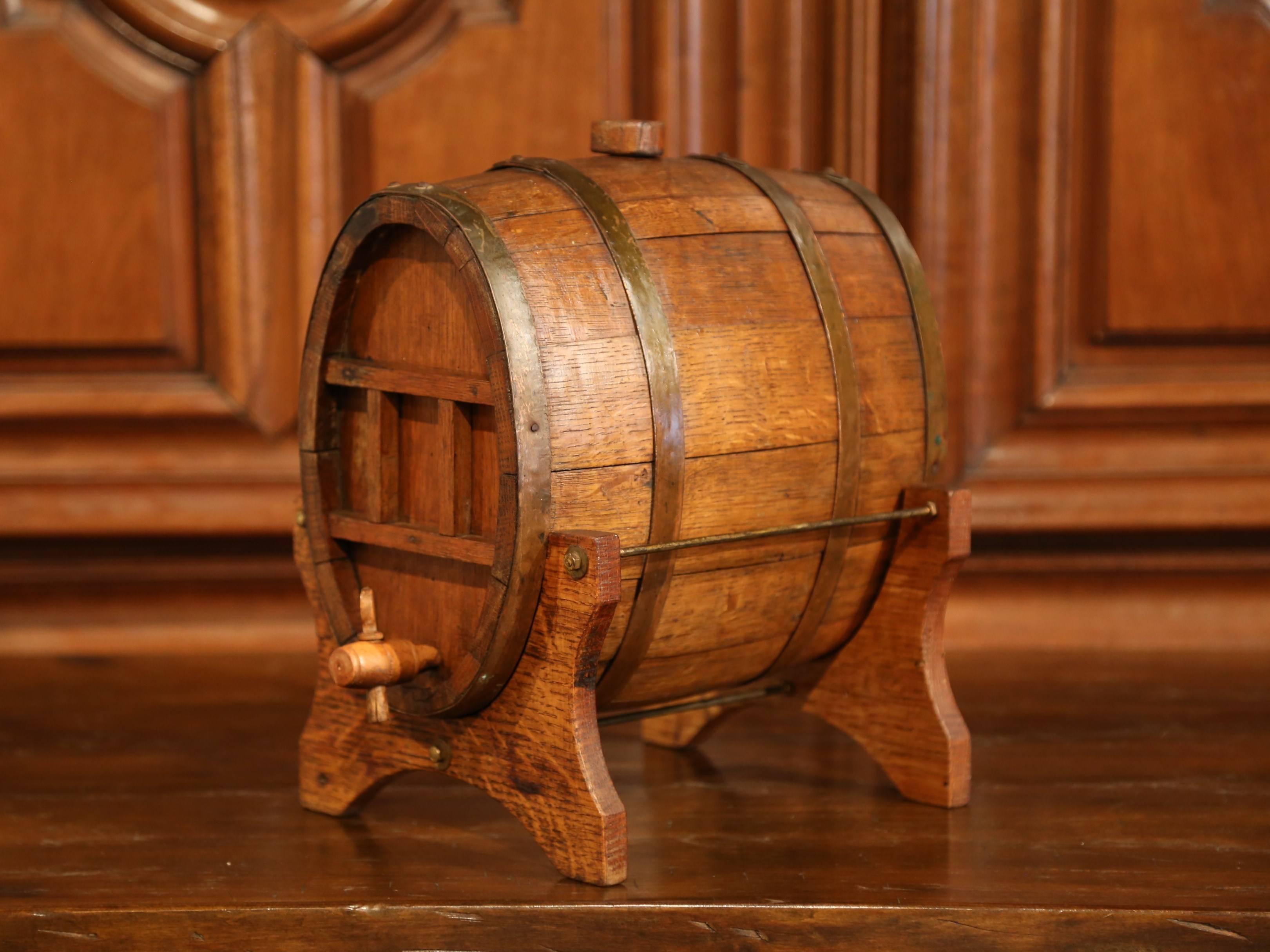 Accessorize your bar with this antique brandy barrel from Normandy; crafted circa 1880, this oval oak barrel embellished with metal rims was used in the days to hold Calvados for an after dinner drink. This one features the original wooden faucet
