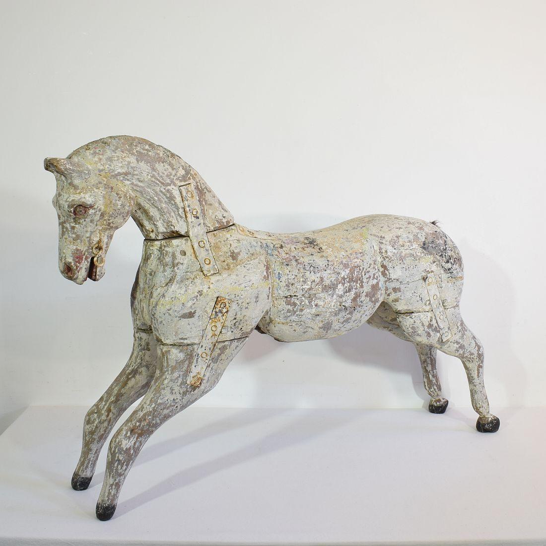 Beautiful carousel horse with traces of its original paint and the stunning patina. 
France, circa 1850-1900.
Weathered, small losses and old repairs.
More pictures available on request.