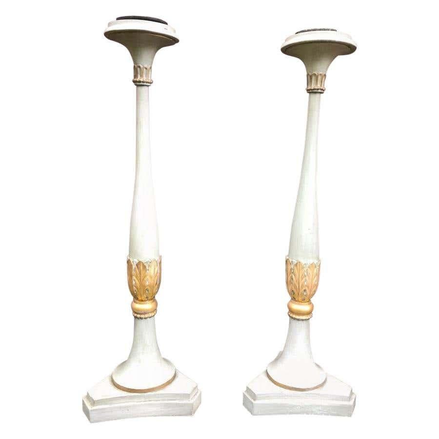 A gorgeous pair of 19th century French carved wood floor standing candlesticks.