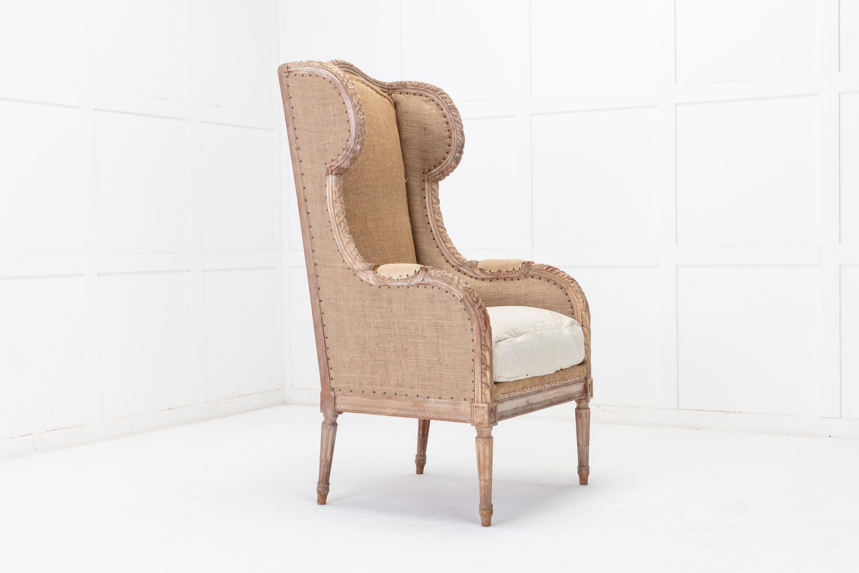 19th century French carved wood wing chair with original paint. Having pretty and decorative carved detailing. It has well-proportioned height and seat depth measurements for sitting comfortably and has been stripped back to calico and hessian. Can