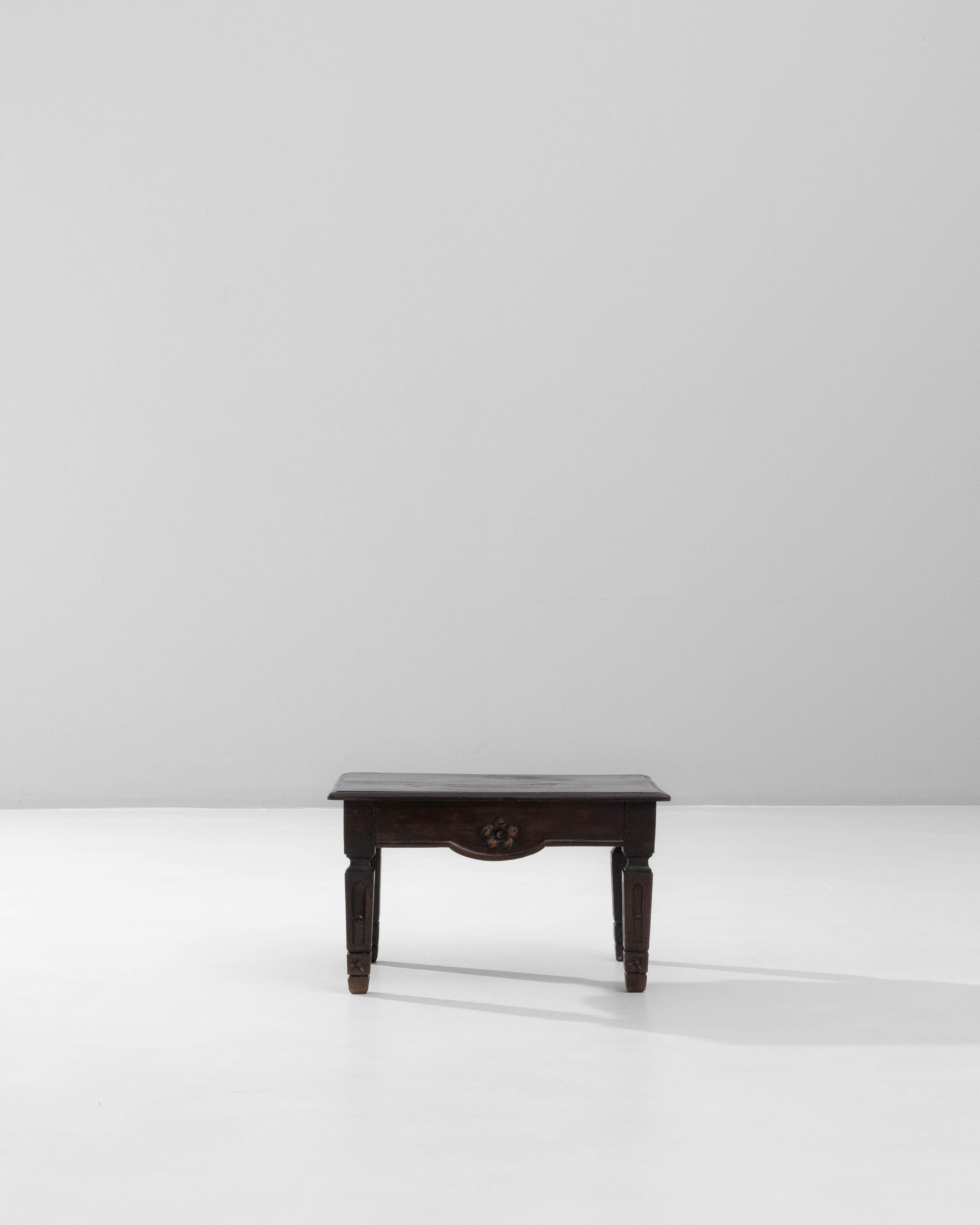 19th Century French Carved Wooden Coffee Table. This compact coffee table showcases the rich craftsmanship and decorative sensibility of 19th-century French woodworking. Made from solid wood with a deep, timeworn patina, it features a thick