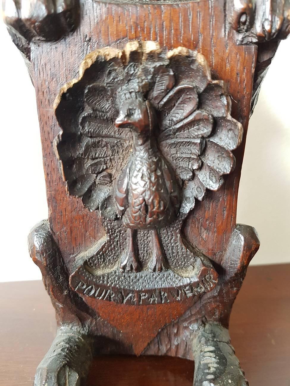 19th century French carved wooden lion holding a shield with a peacock and below the text 