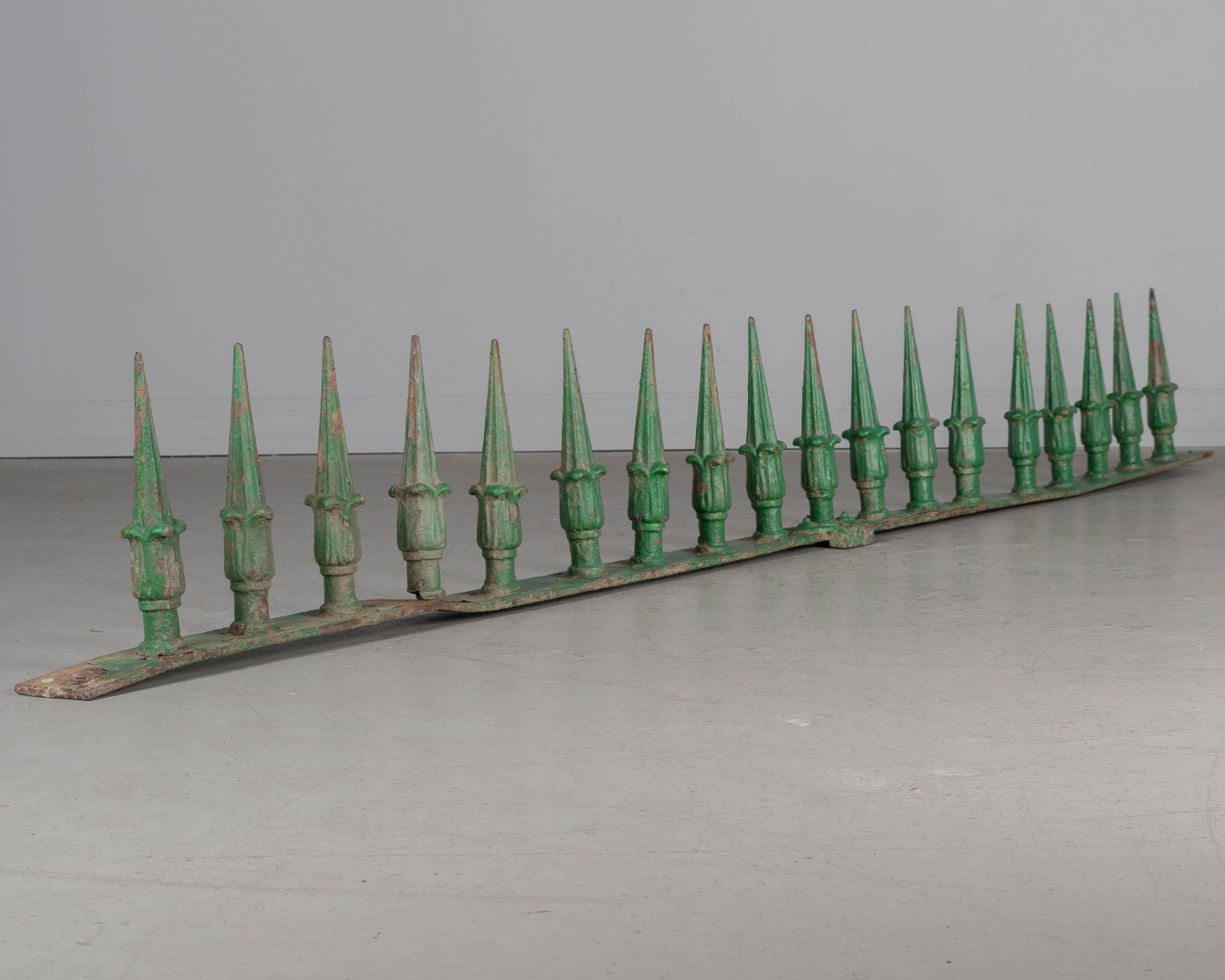 A 19th Century French decorative architectural wall spike rail with 18 cast iron spears. Original green painted patina with some paint loss and rust. One spear is bent. Circa 1870-1890.
Dimensions: 84