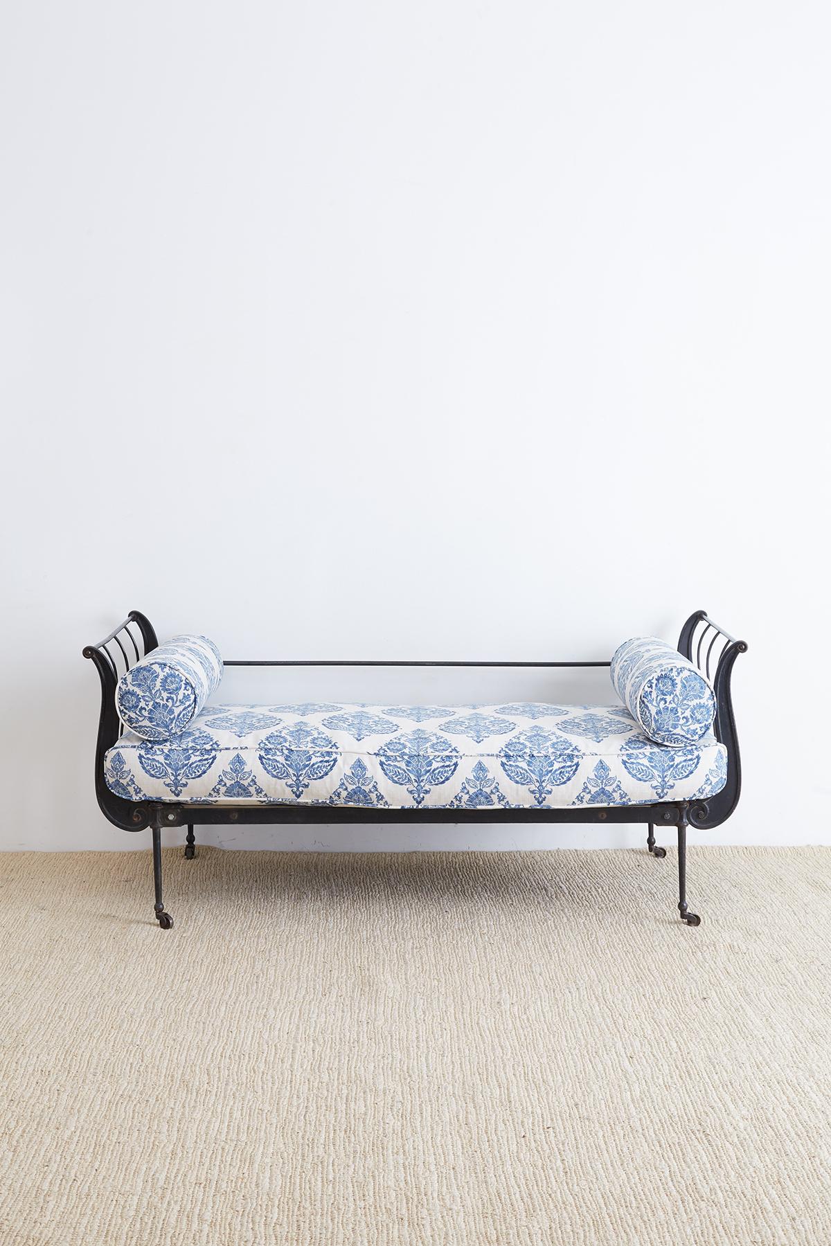 Fabulous late 19th century, French cast iron daybed with a modern blue and white linen redux. Elegant cast iron frame made in a simple refined style free from ornate decorations. The back has been later reinforced with two cross stretchers. Newly