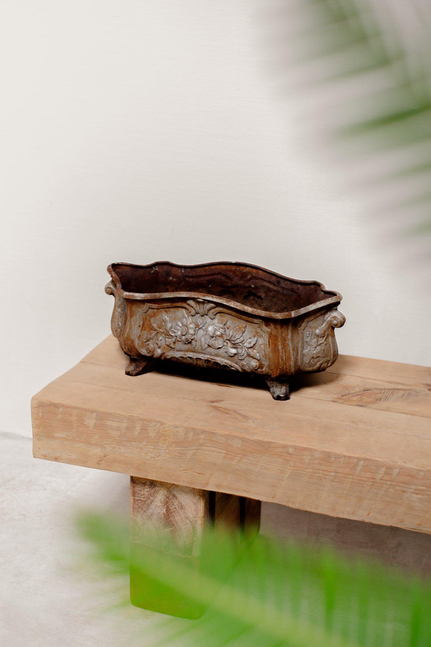 This 19th Century Louis Philippe Style French Cast Iron, Footed Jardinière is a stunning piece that exudes old-world charm and elegance. Crafted from durable cast iron, this jardinière features intricate detailing and a beautiful aged patina that