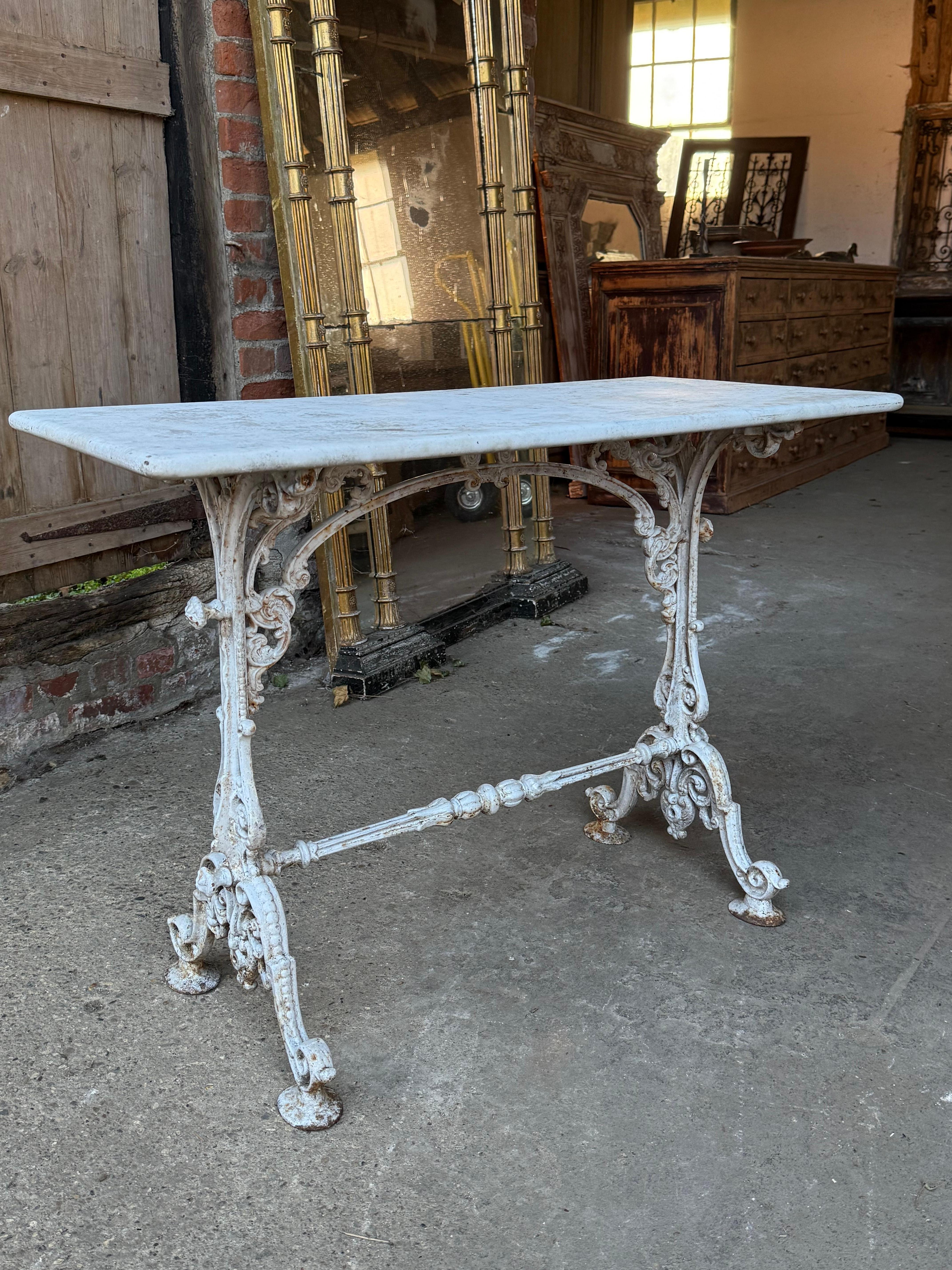A lovely late 19th century French bistro table with a cast iron base and original marble top. The decorative ironwork base has nice old paint giving it a great look. This could be used indoors as well as the garden.

Please contact us for a