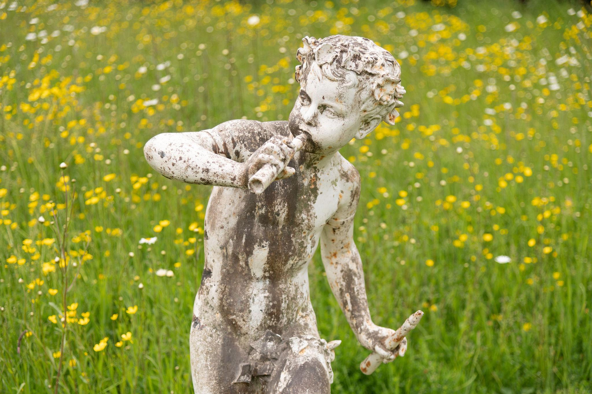 A beautiful and very high quality French 19th century cast iron statue of a young boy dancing and skipping while playing the flutes, signed by the famous A. Durenne sommevoire. Exceptional fine detail, grapevine and leaves, just simply the best
