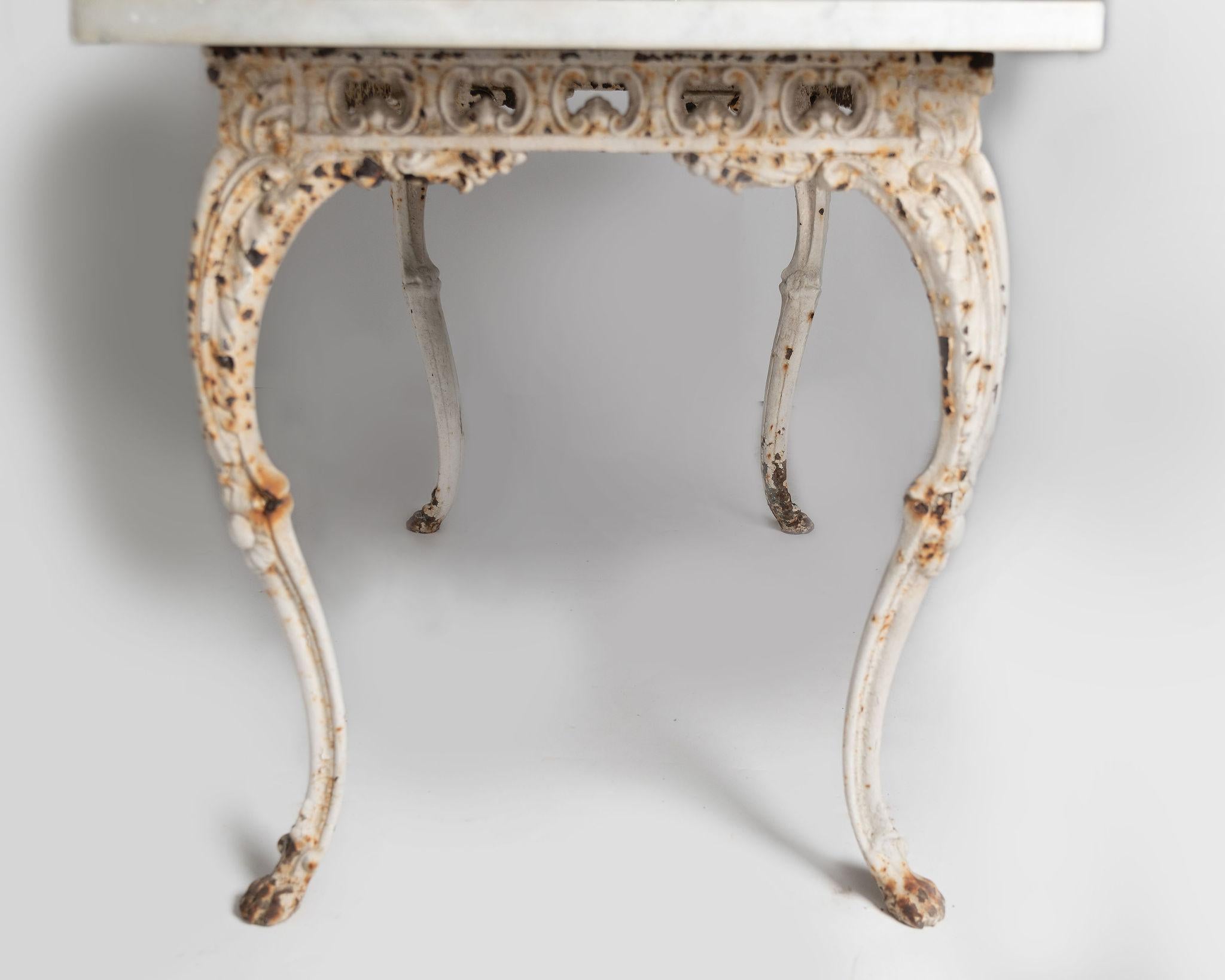 19th Century Napoleon III period openwork cast iron table with carrara marble top. Delightful lion paw feet, original paint. Detail to all four sides. Light age related wear, marks to the marble as to be expected. The base is separate to the top.