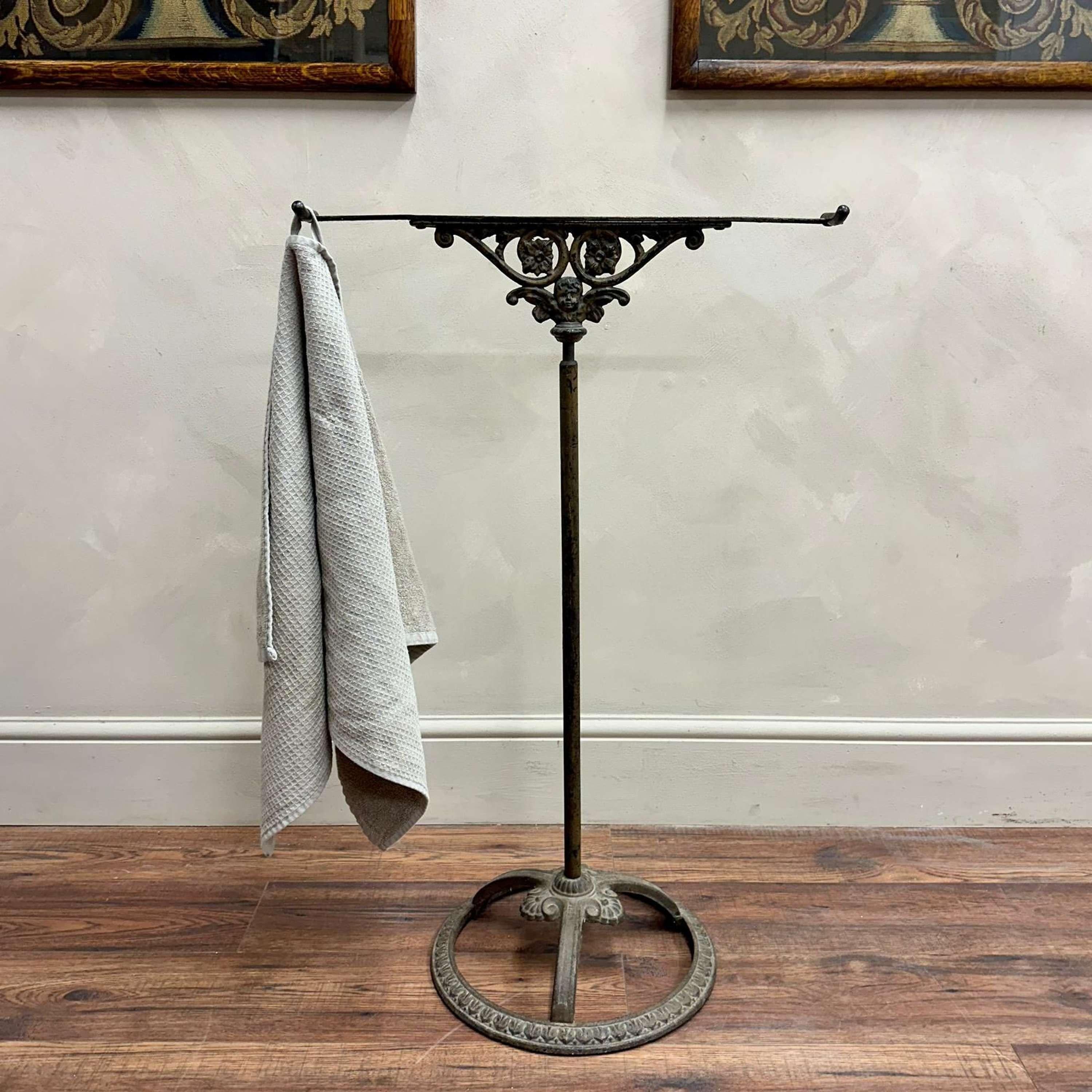 A French cast iron towel rail, detailed cherub design with an ornate base. 
2 hooks for towels or to be folded over in a bathroom interior.

France, circa 1880.

Height - 90 cm
Width - 58 cm
Base Diameter - 35.5 cm
Please message if any further info