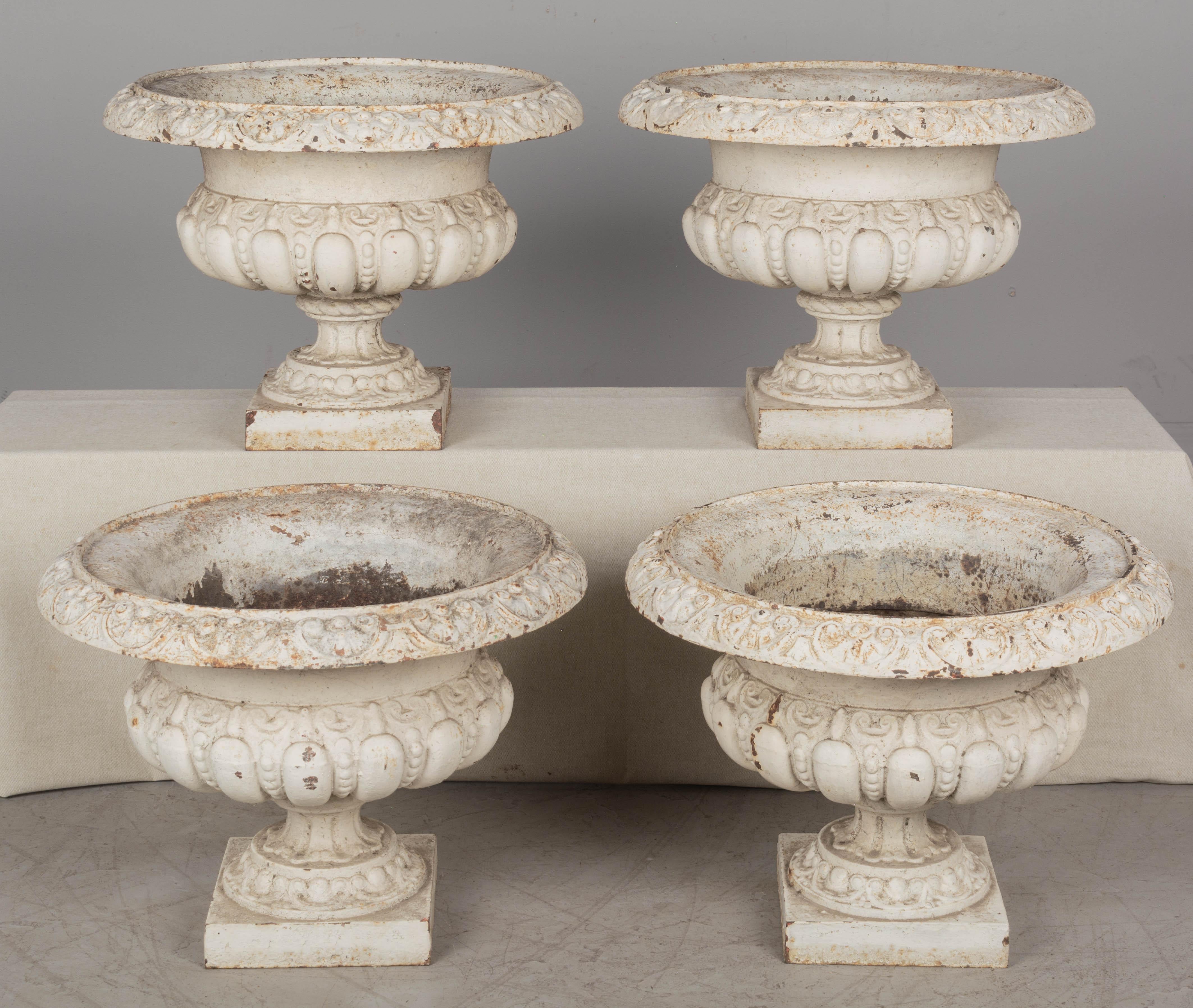 A set of four 19th century French cast iron white painted garden urn planters. Original weathered rusty patina. One urn has a chip in the rim. Circa 1870-1880.
Weight: 54 Lbs each
Dimensions: 16