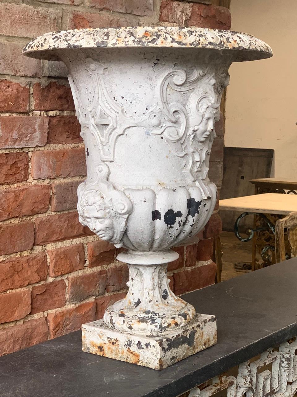 A beautiful 19th century French cast iron urn from the south of France. It is very nice quality with beautiful decoration including four face masks. 
This could be used indoors as a vase or in the garden as a planter.
Please contact us directly for