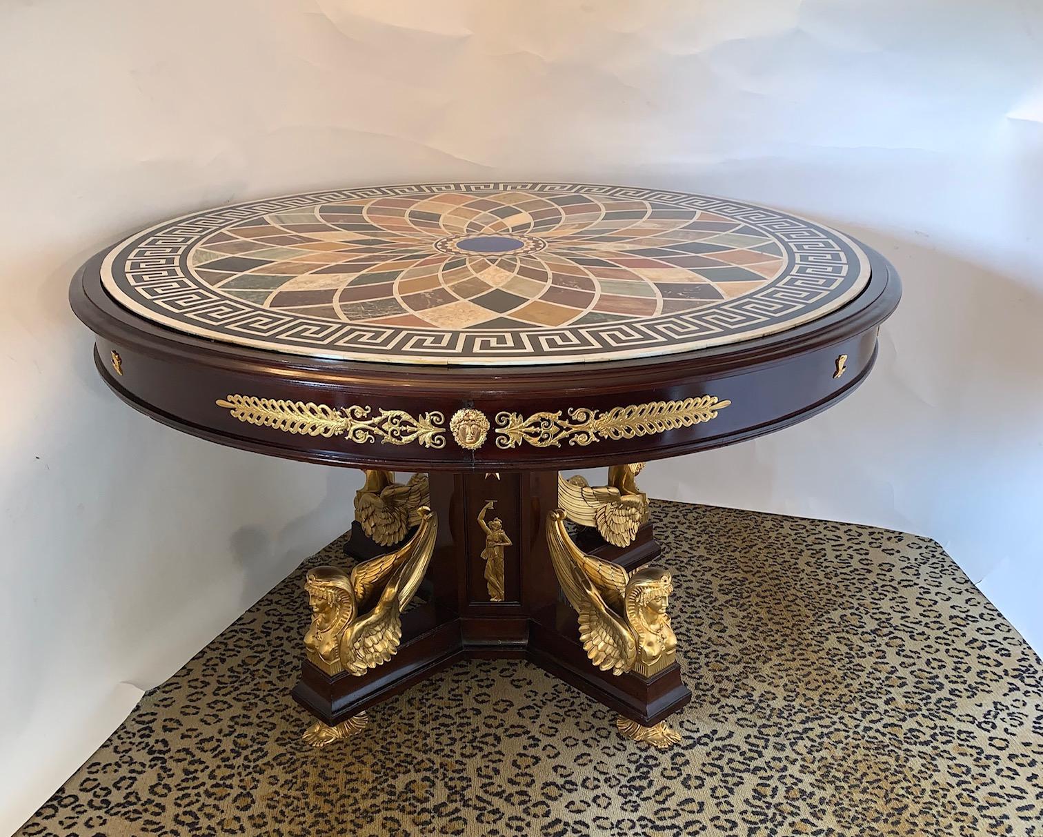 19th century French center table with gilt bronze sphinx and mahogany wood, 19th century, France.