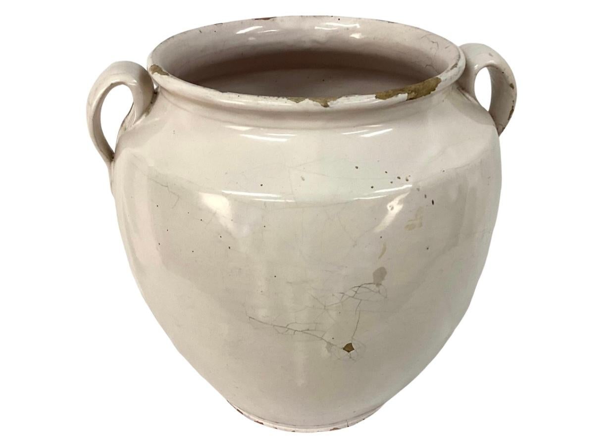 19th century French Country earthenware confit pot with two handles and overall white glaze. These pots were once used daily in French homes to store fruits, preserves or honey. Mouth of jar measures 7.25