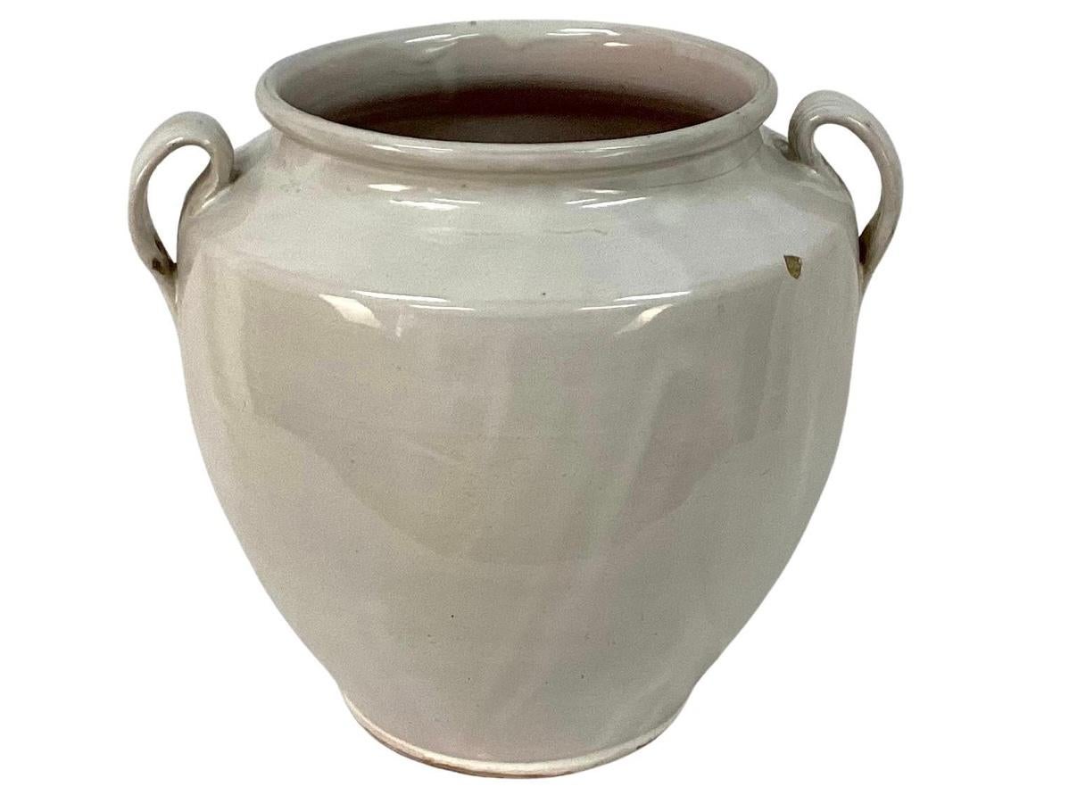 19th century French Country earthenware confit pot with two handles and overall white glaze. These pots were once used daily in French homes to store fruits, preserves or honey. Mouth of jar measures 6.75