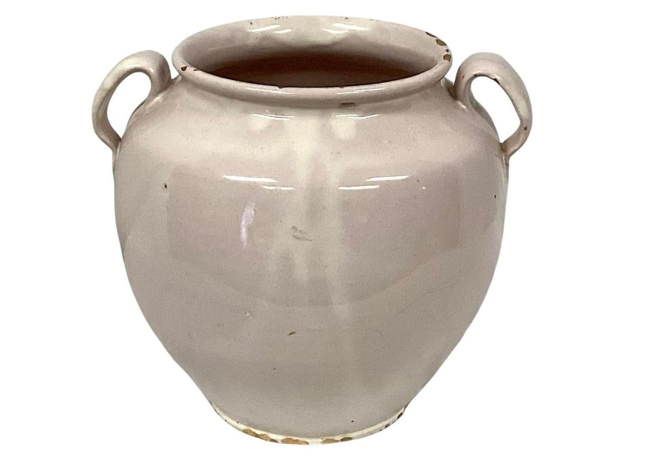 19th century French Country earthenware confit pot with two handles and overall white glaze. These pots were once used daily in French homes to store fruits, preserves or honey. Mouth of jar measures 5.5