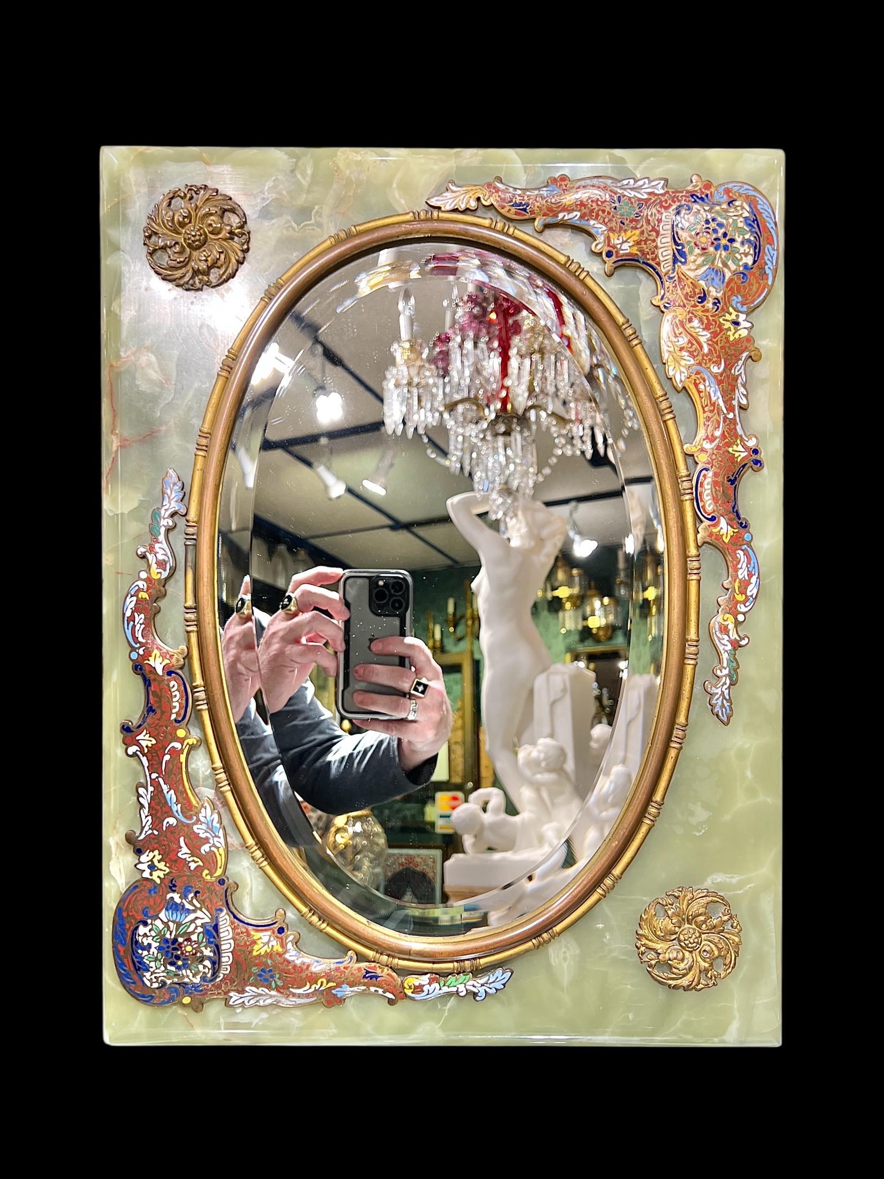 Antique (late 19th century) French table or boudoir mirror finely crafted from green onyx stone and mounted with bronze stand and and inlaid with champleve enamel designs.  With oval beveled glass mirror in very good condition.  18 1/2 by 14 by 7/8