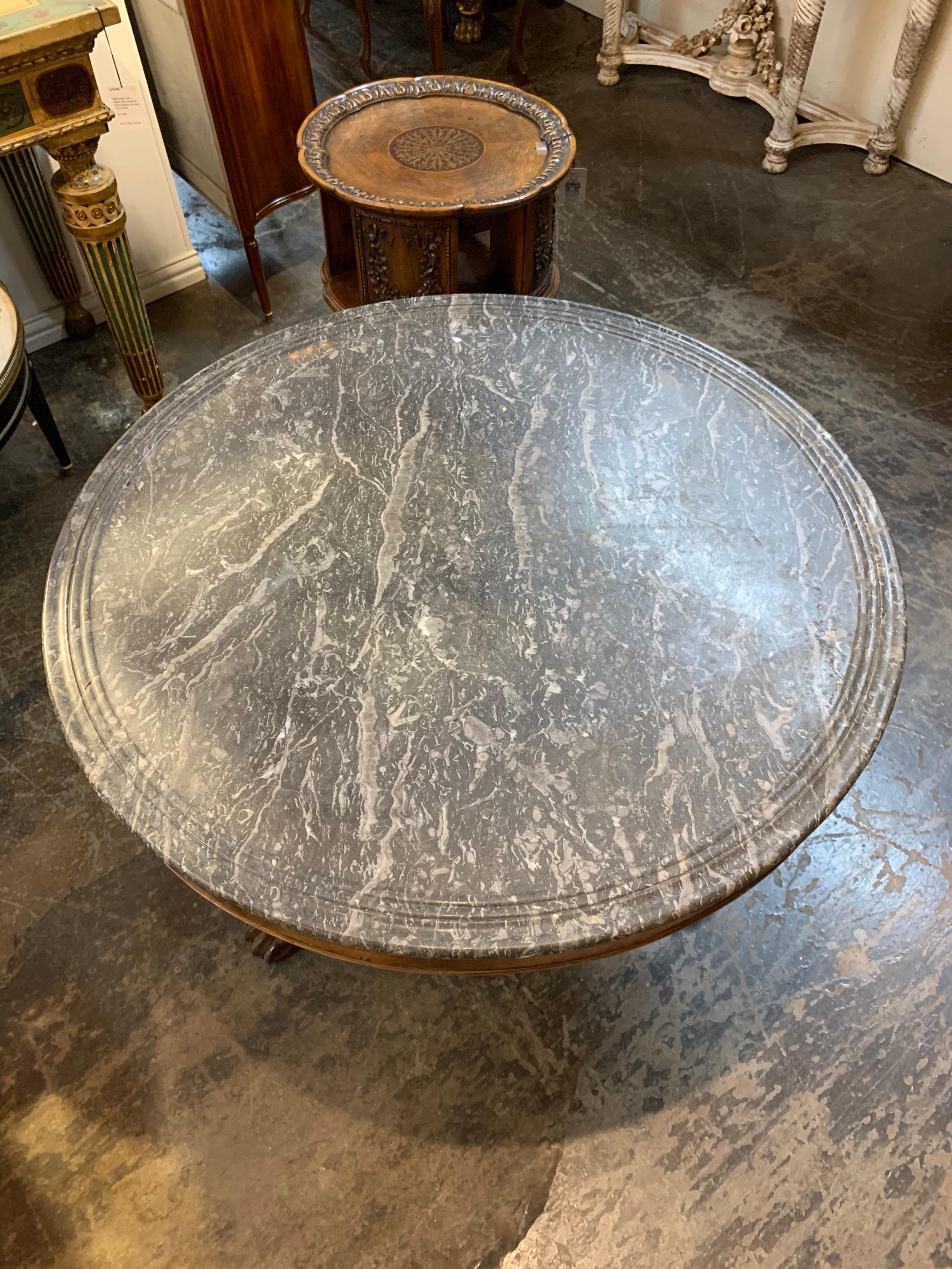 Very handsome 19th century Charles X carved mahogany table. Nice carvings and the piece has an original grey marble top. A beautiful classic style!