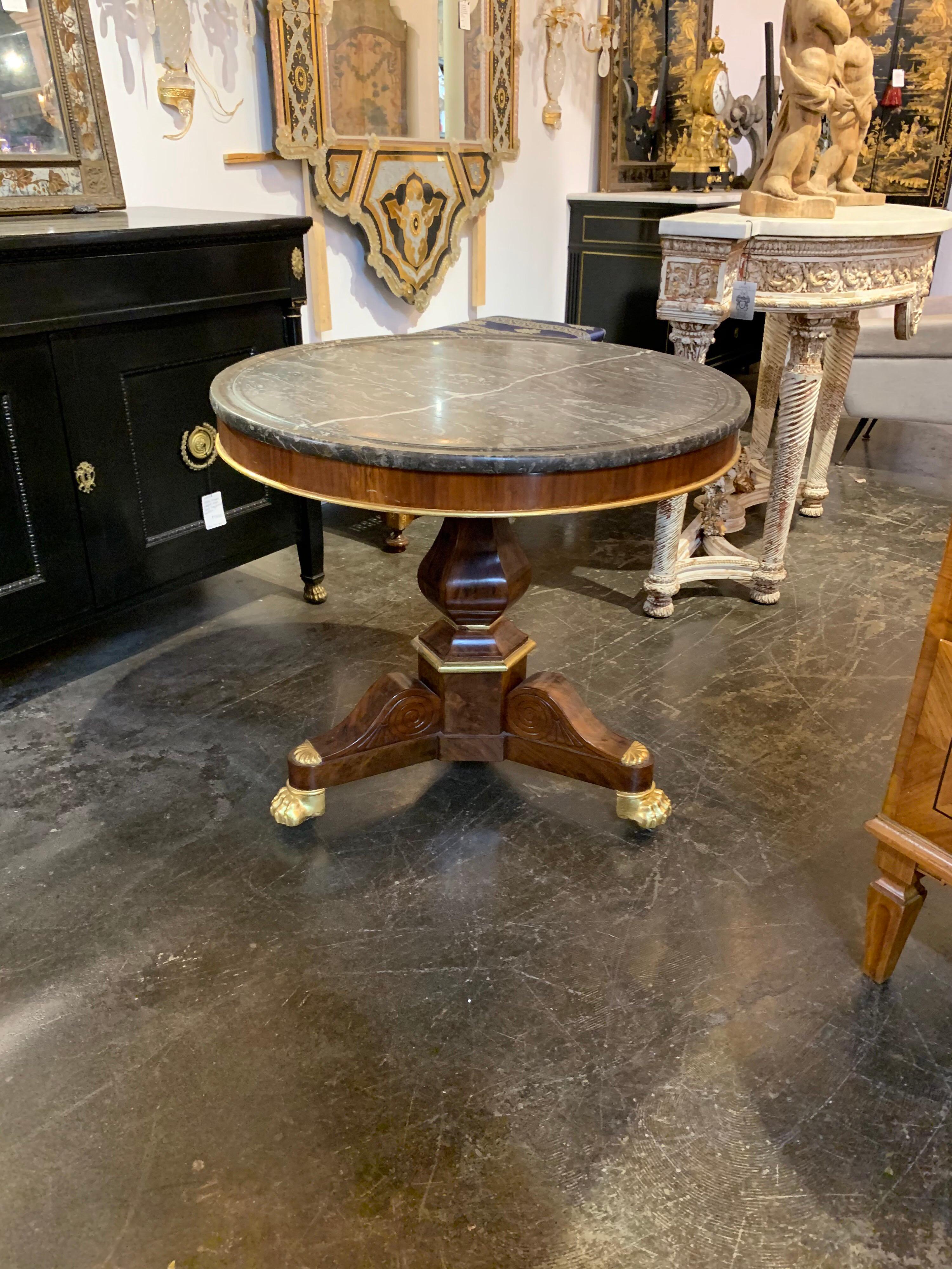 Elegant 19th century French Charles X-mahogany side table with grey marble top. The table has a lovely base with gold gilt details. Very pretty!
