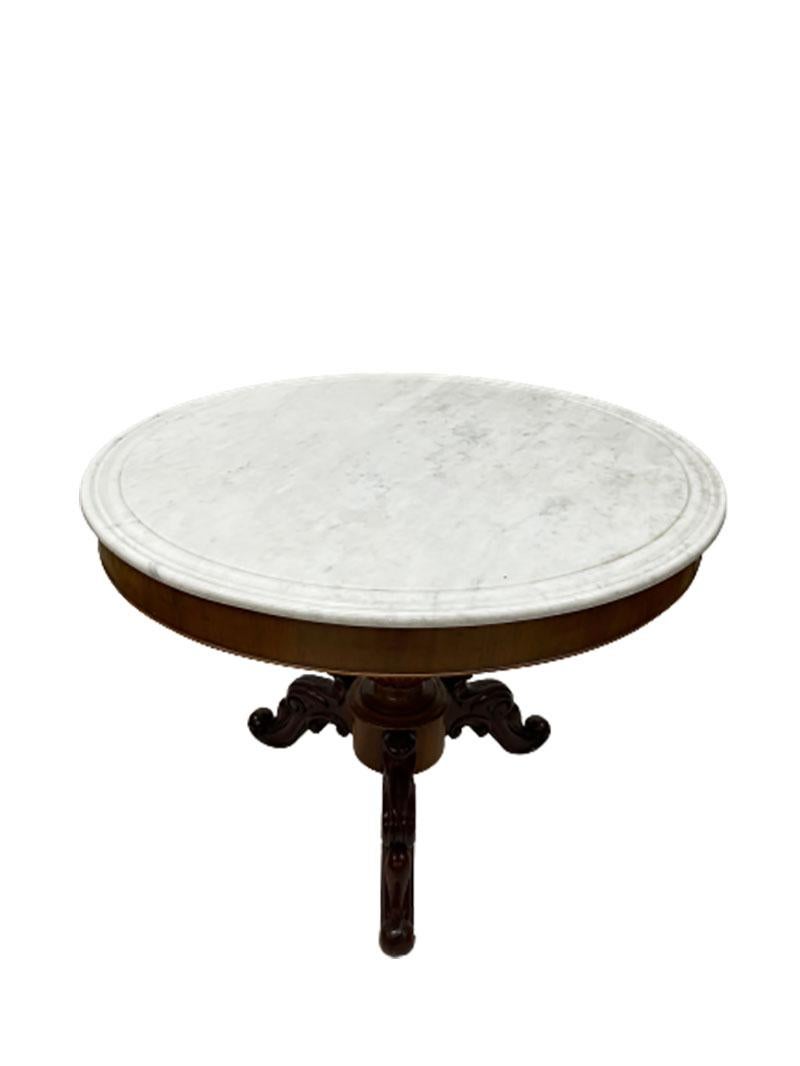19th century French Charles X table with white marble top.

A mahogany table with it's original white marble top
and with reversed scroll pattern legs and urn shaped column,
1840-1860, France
The table measures 74.5 cm high and 99 cm diagonal.