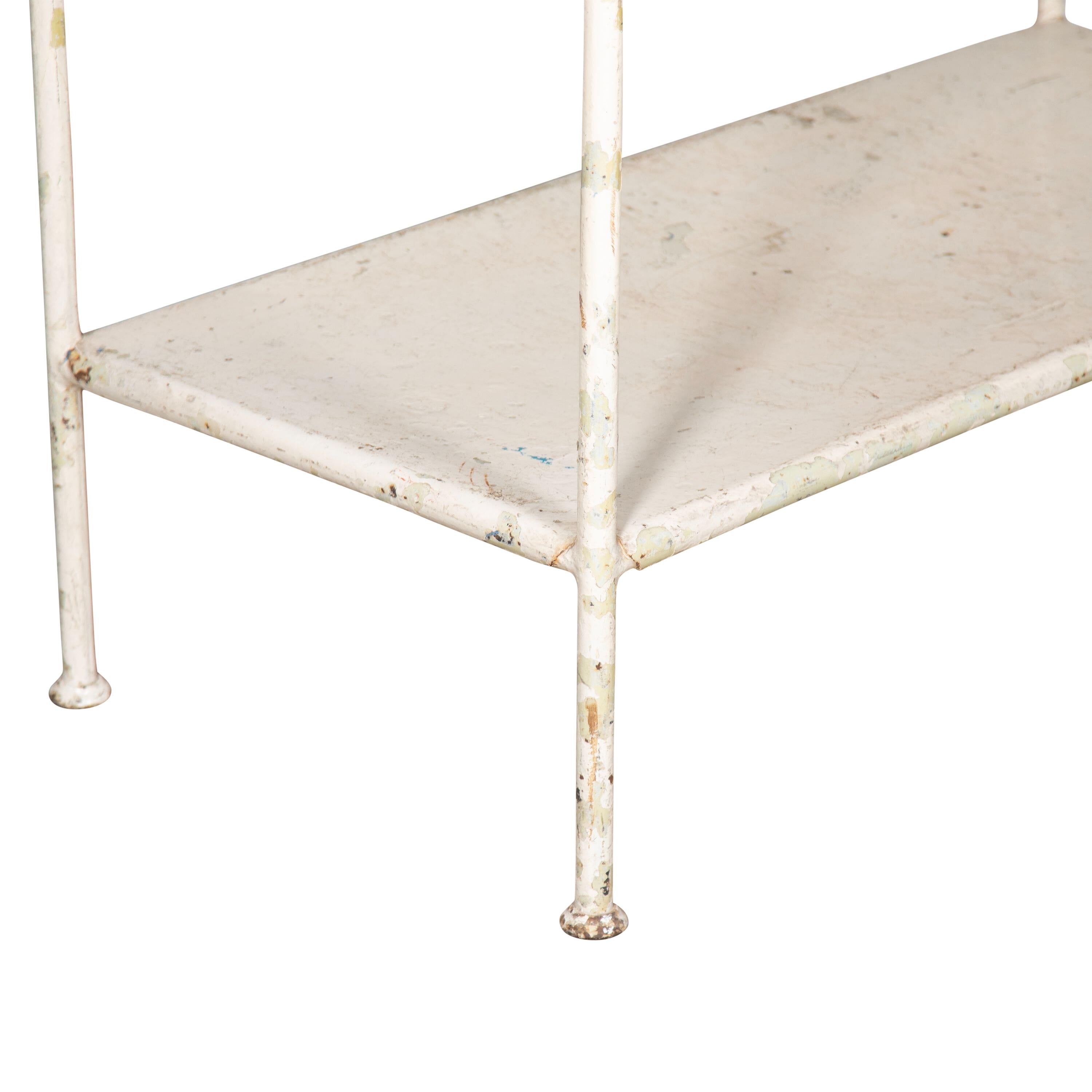 19th Century French cheese display table.
The base is painted metal and the large top is made of porcelain. This would be an ideal kitchen island, folding table in a utility or back as a shop display.