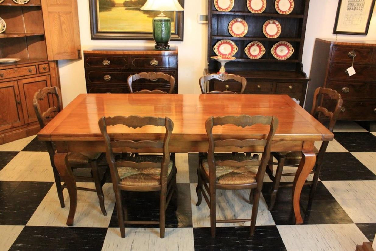 Late 19th century French cherry farm table with knife drawer and breadboards ends. Table stands on graceful cabriole legs.