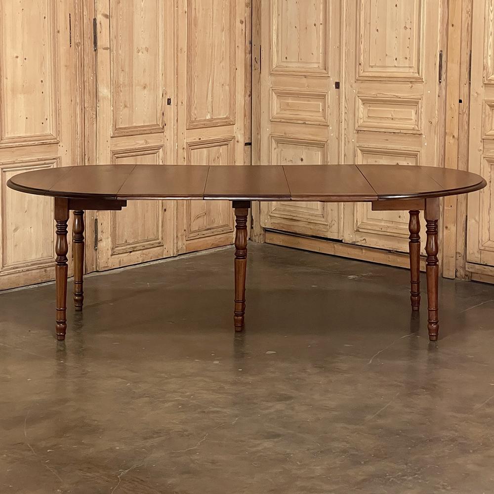 19th century French Cherrywood drop leaf dining table with leaves is a remarkable example of ingenious craftsmanship, expressed by French artisans in a manner also common to English furniture makers. In this case, select cherry wood was hand-picked