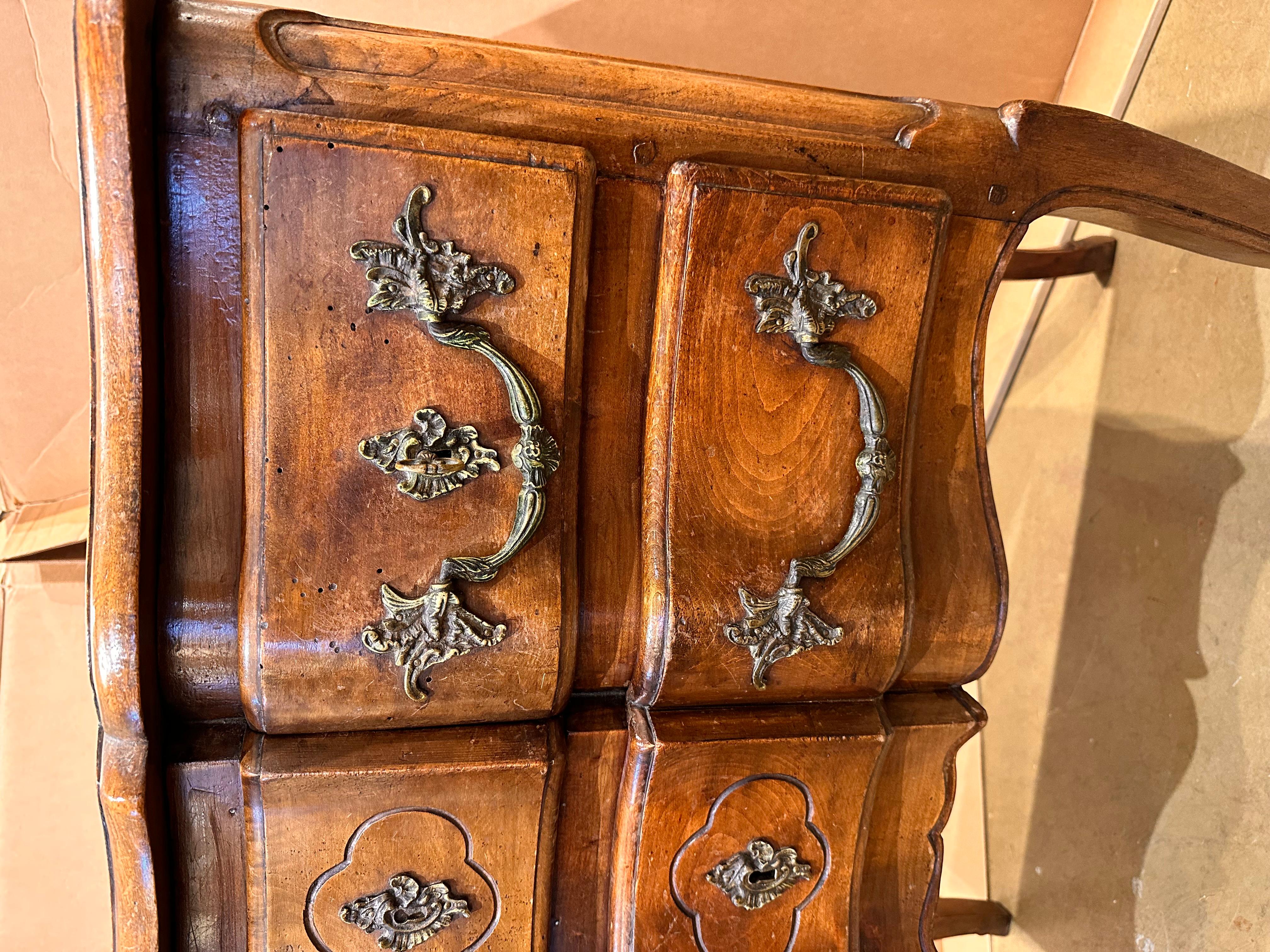 This is such a beautiful little French chest! For a small piece this chest carries itself well. It has a lovely patina that shows up the natural detail of the wood. The front shows the marks of excellent craftsmanship with a curved front that