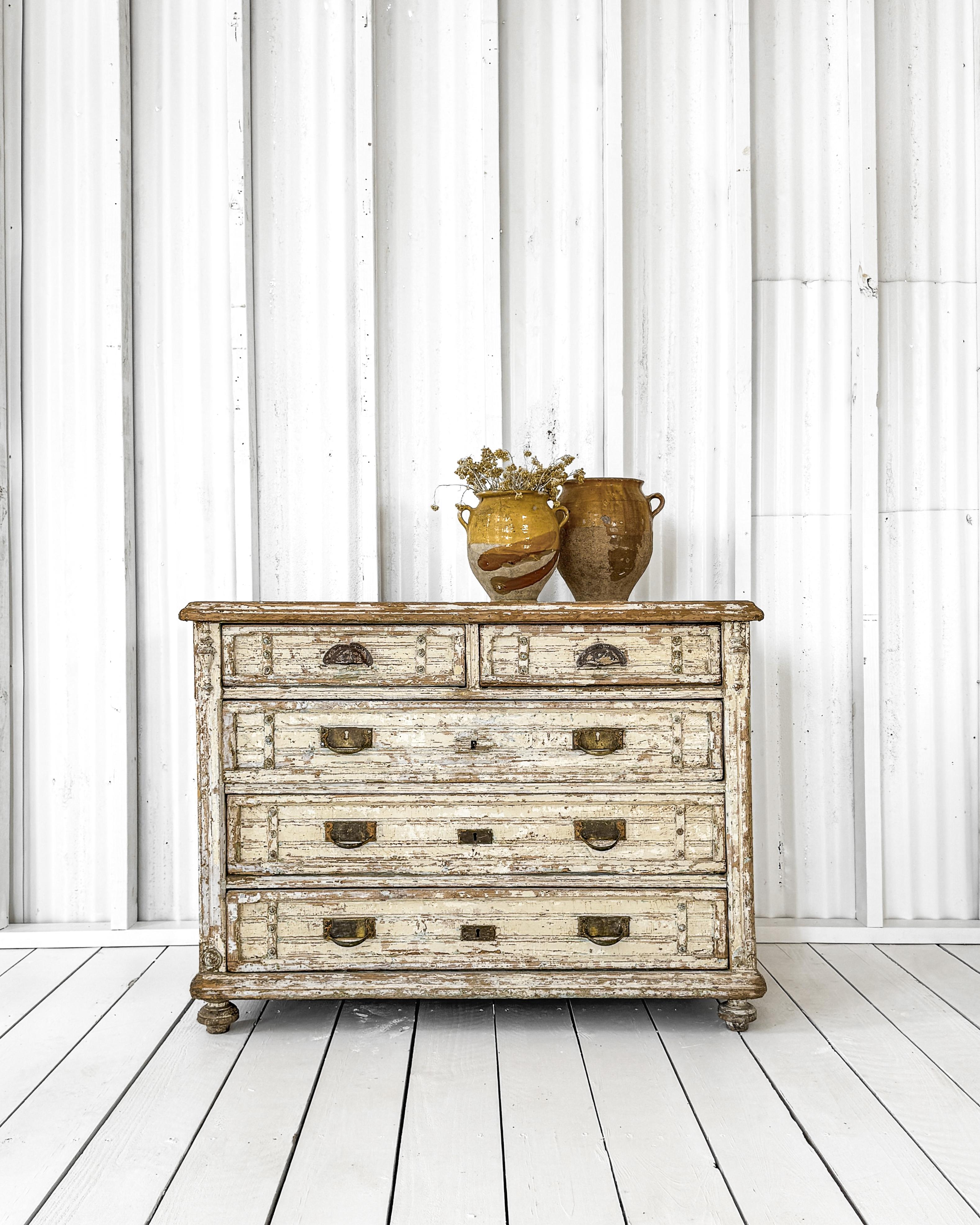 A lovely quintessentially French chest of drawers. A classic piece that was very well made (in the early 1800s) by a skilled craftsman. The two-over-three configuration features a paint finish that is nothing less than perfect. Lightly dry scraped