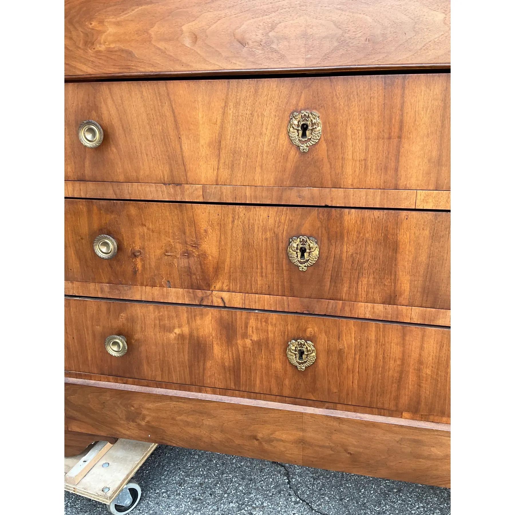 This is a beautiful French chest of drawers, dating to the mid 1800s. The mahogany wood has soft warm tones and is accented by the ornamental brass knobs and key holes. The black marble makes the perfect topper! This would make an elegant bedroom