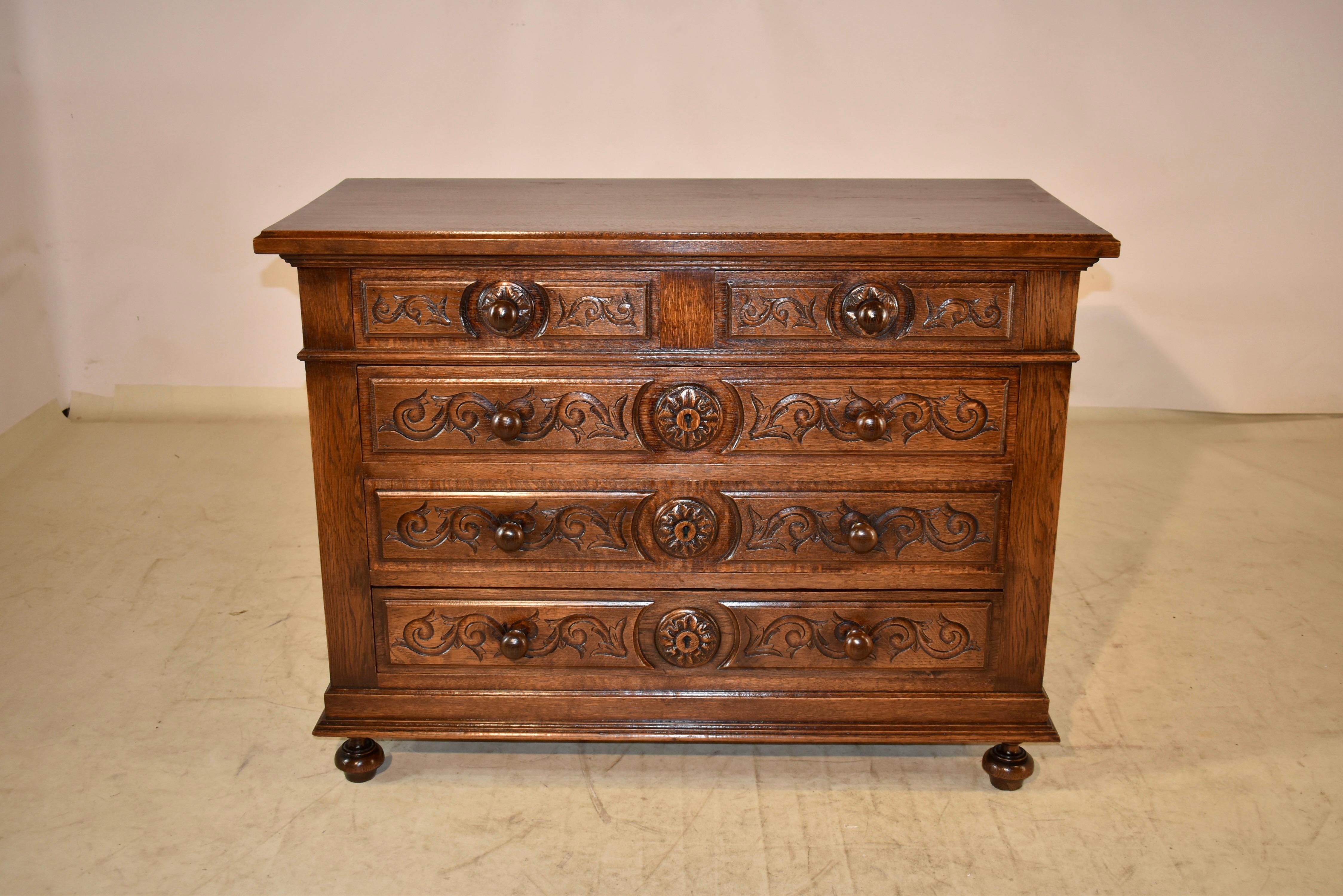 19th century oak chest of drawers from France with a beveled edge around the top, following down to simple paneled sides and two over three drawers in the front of the case, all with paneled drawer fronts with beveled edges and lovely carved